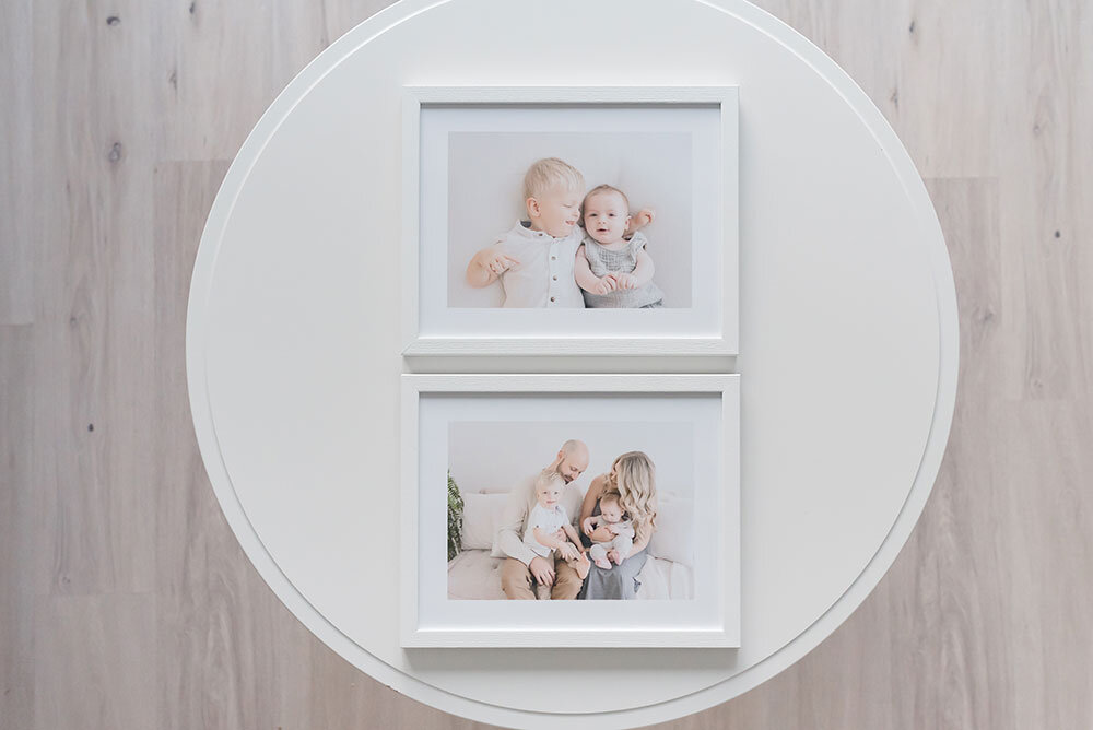 Lay flat of framed family photos on coffee table niagara photography studio