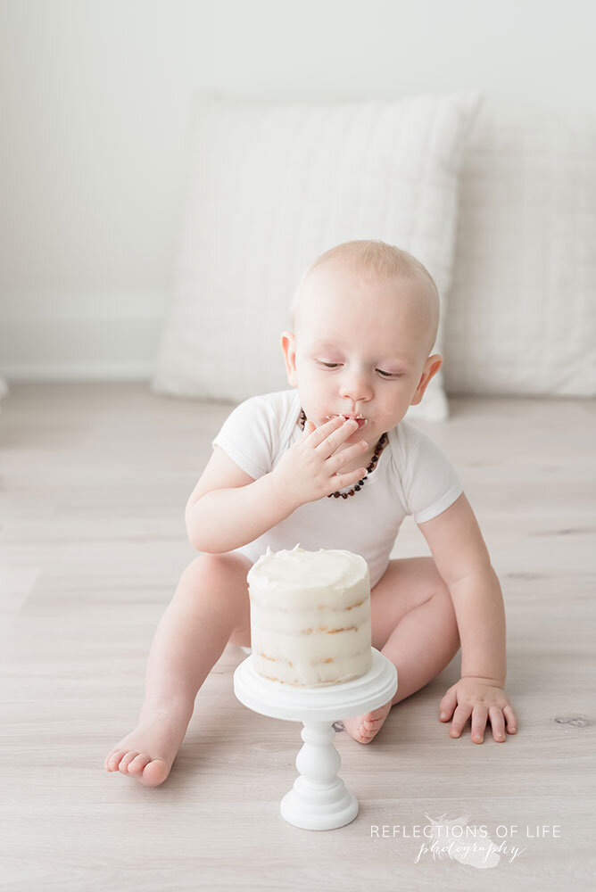 Baby eats birthday cake milestone photography