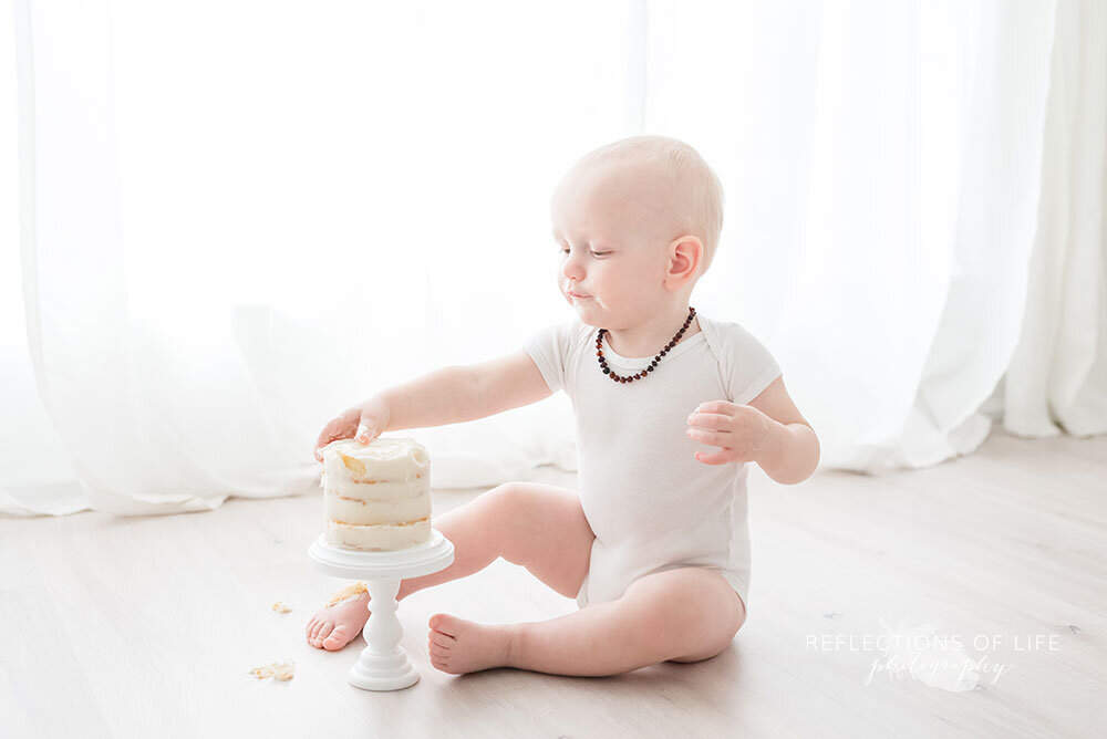 Baby eats birthday cake