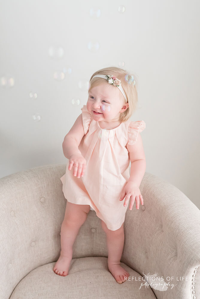 girl playing with bubbles