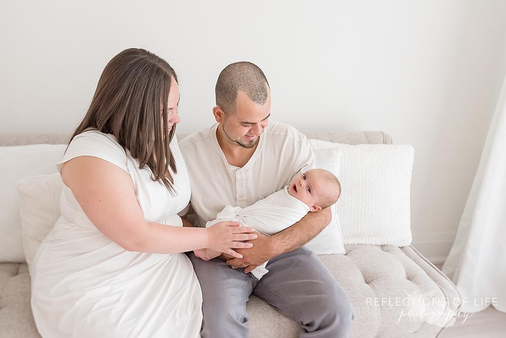 parents holding newborn baby