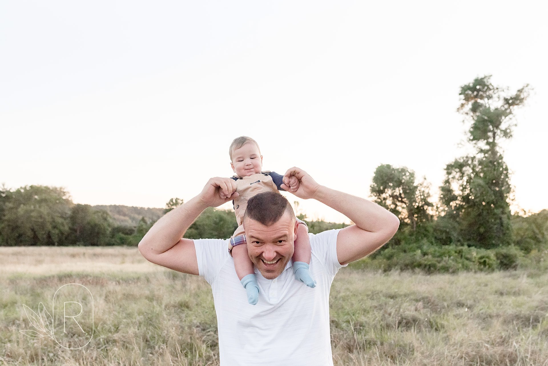 baby boy on dad's shoulders