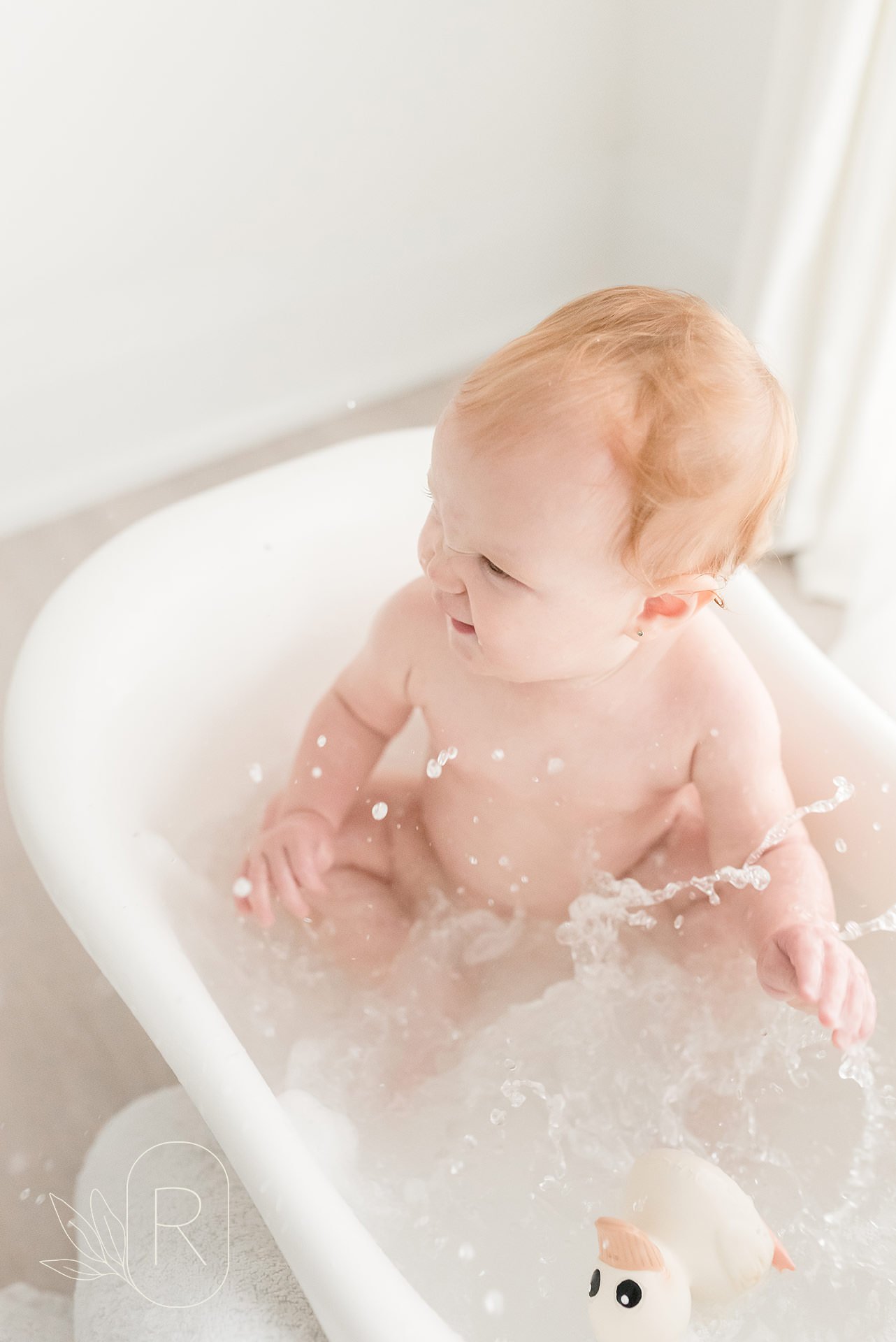 baby splashing in bath tub