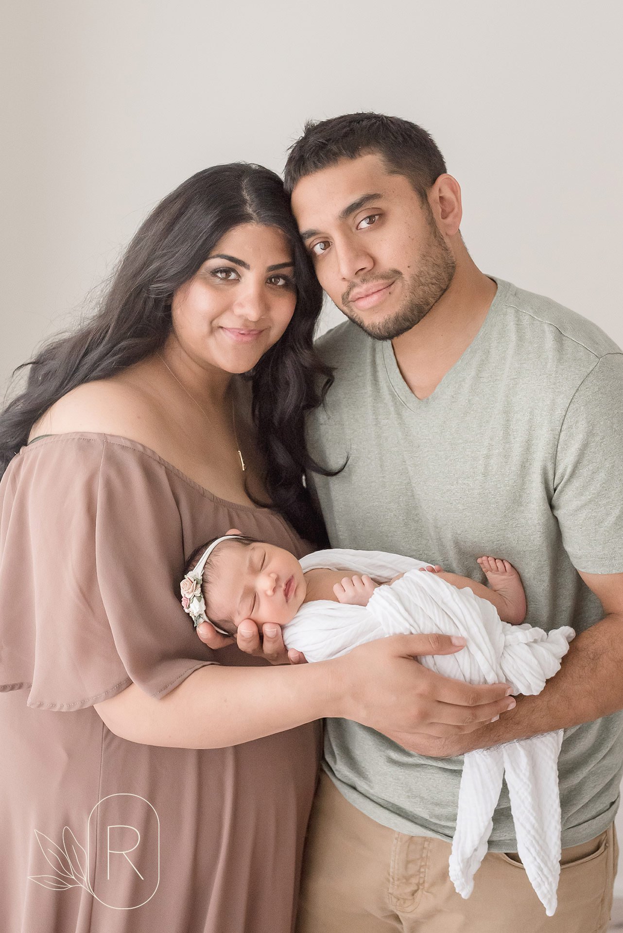 first time parents holding baby