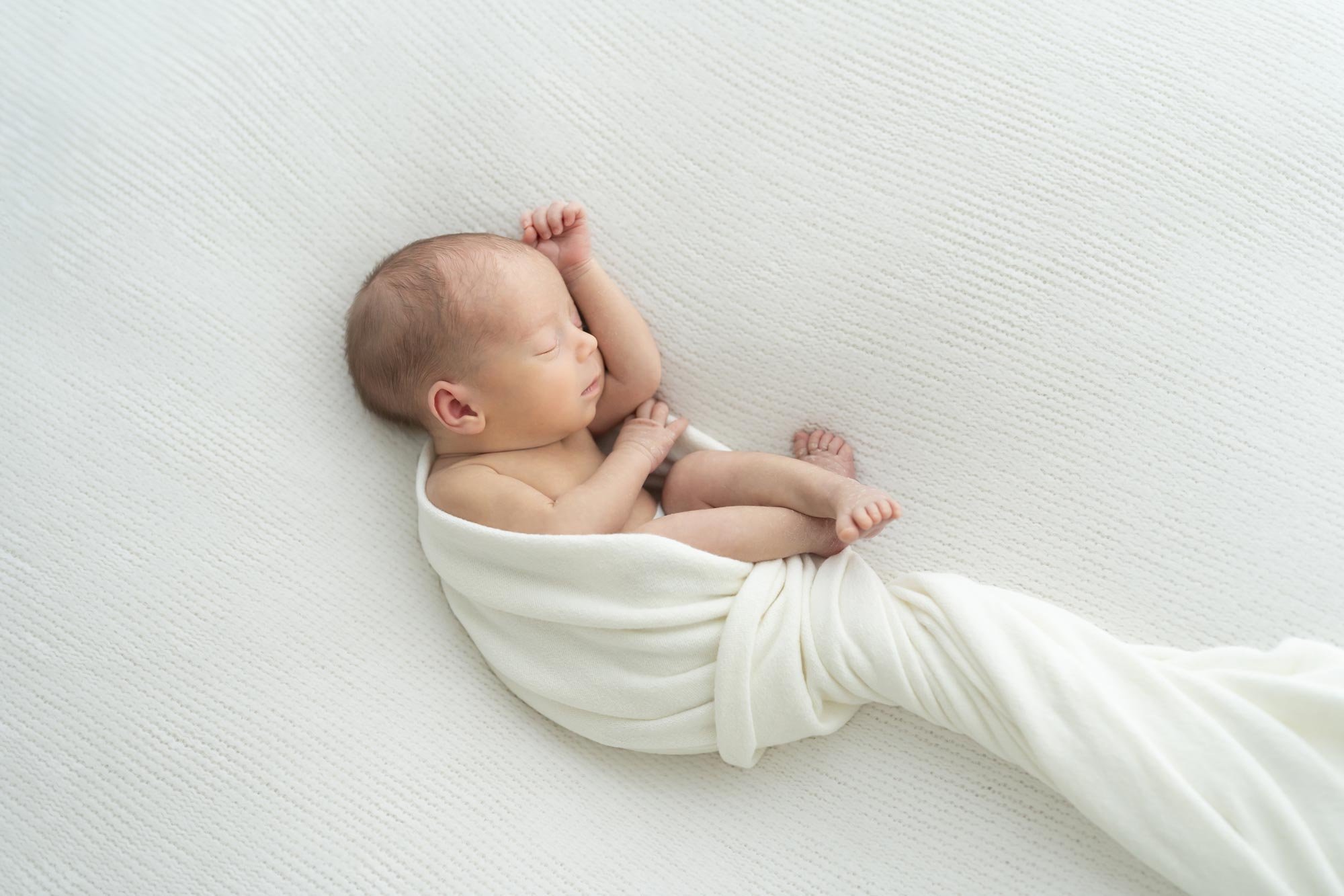 Newborn baby wrapped in white blanket Niagara Newborn Pictures.jpg