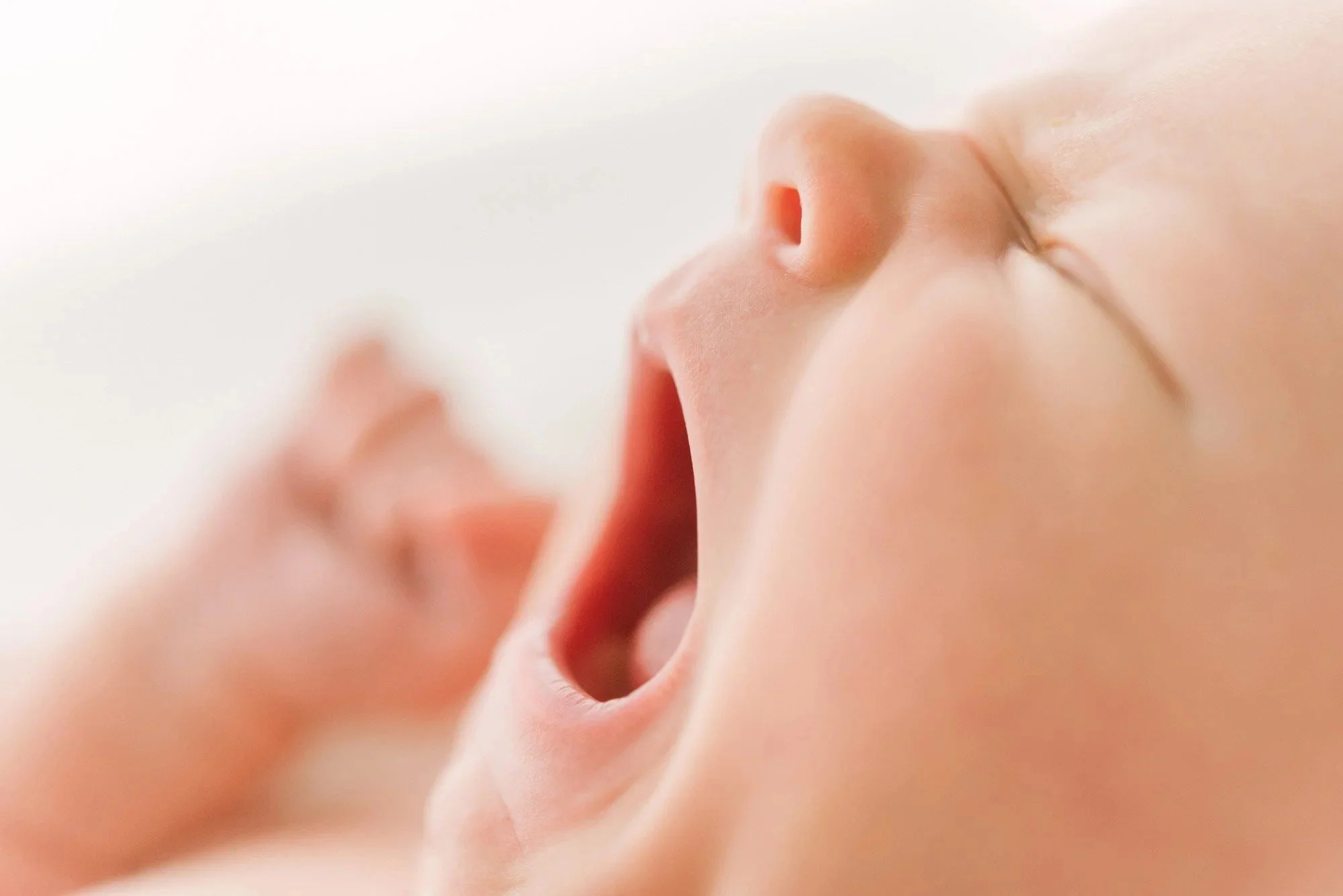 Sleeping newborn baby yawning captured by newborn photographer in Hamilton Ontario​ studio by Reflections