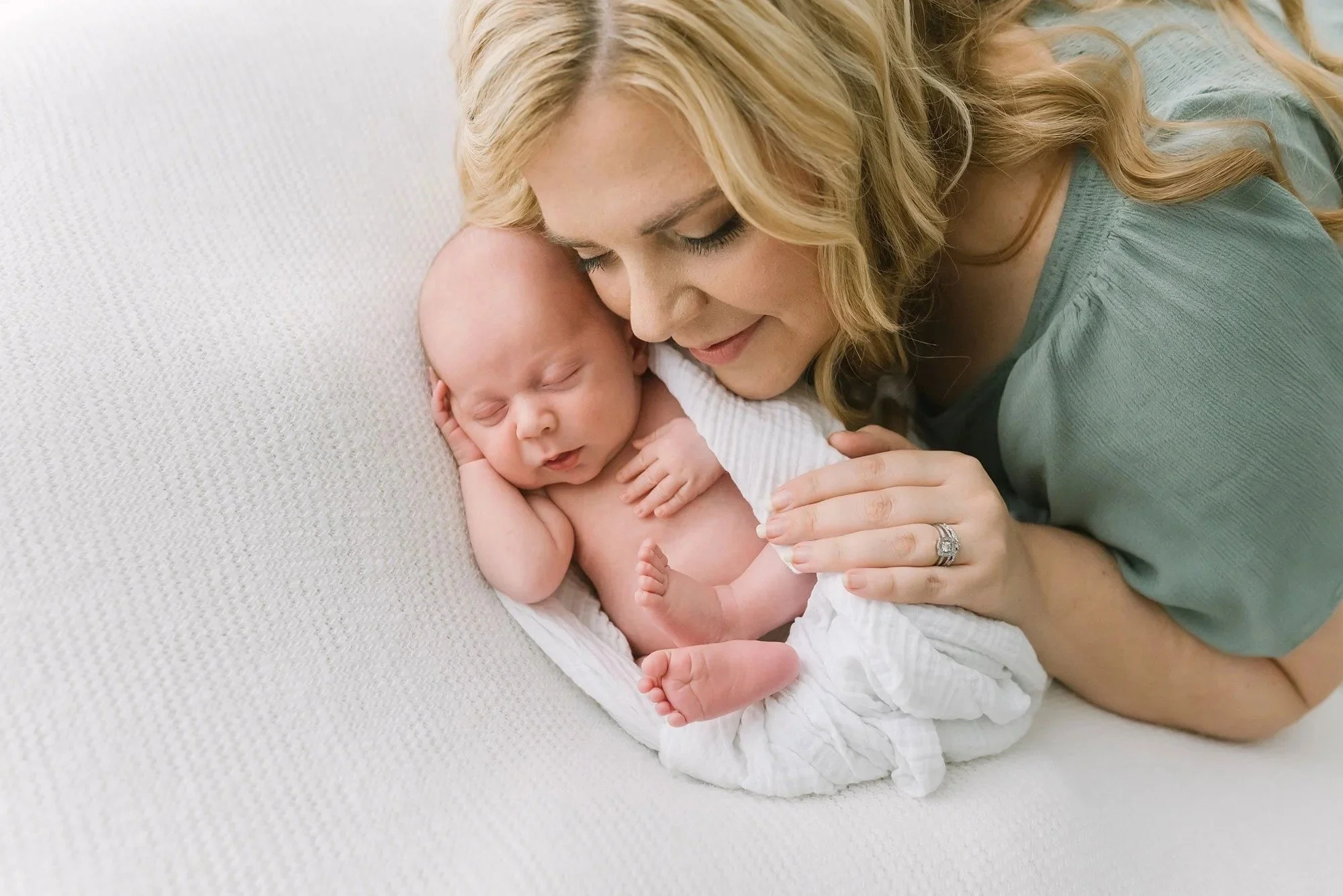 Sleeping baby with mom snuggled up captured by Reflections newborn photography in Hamilton​