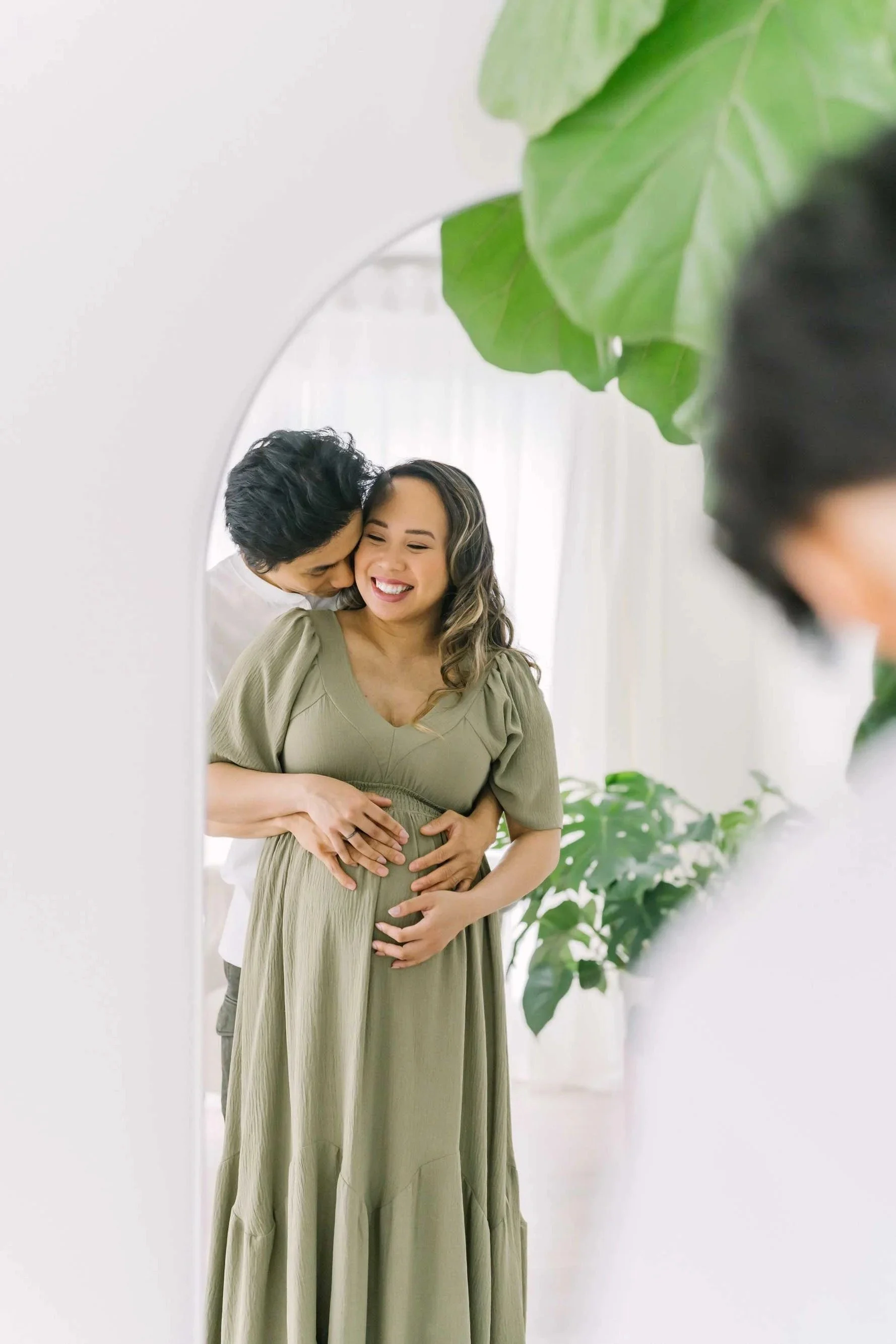 Couple posing for pregnancy photos and maternity photography in the Niagara Region at Reflections studio