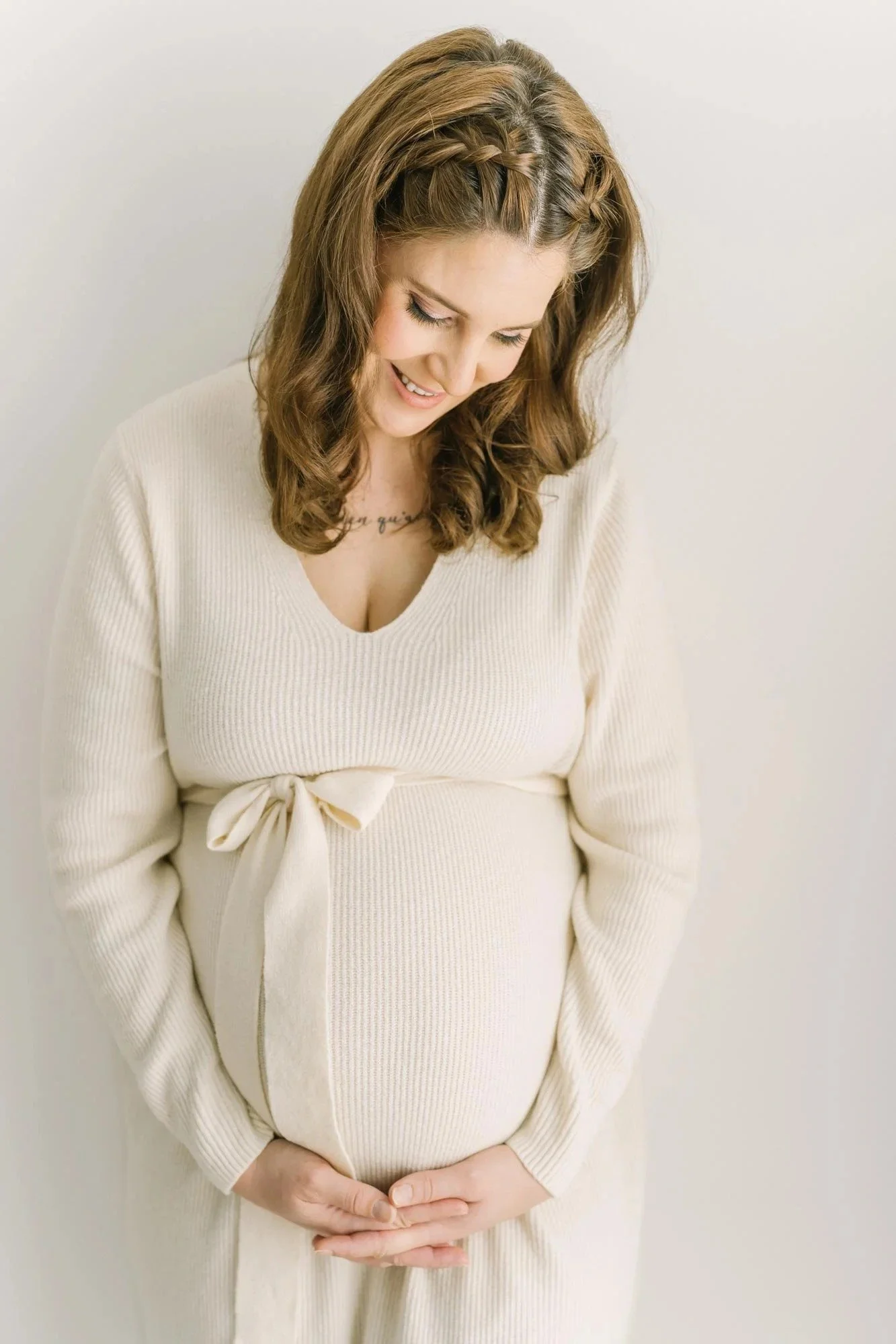 Mom leaning on a wall for Niagara Maternity Photography in the Reflections Photography studio