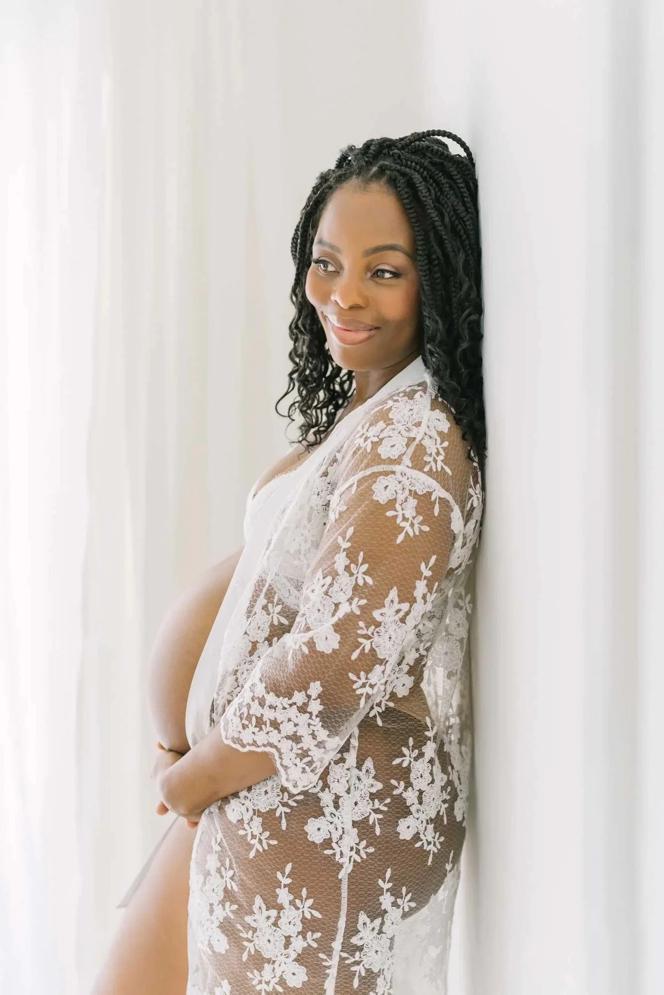 Mom posing for pregnancy and maternity photography in Niagara at Reflections studio near me