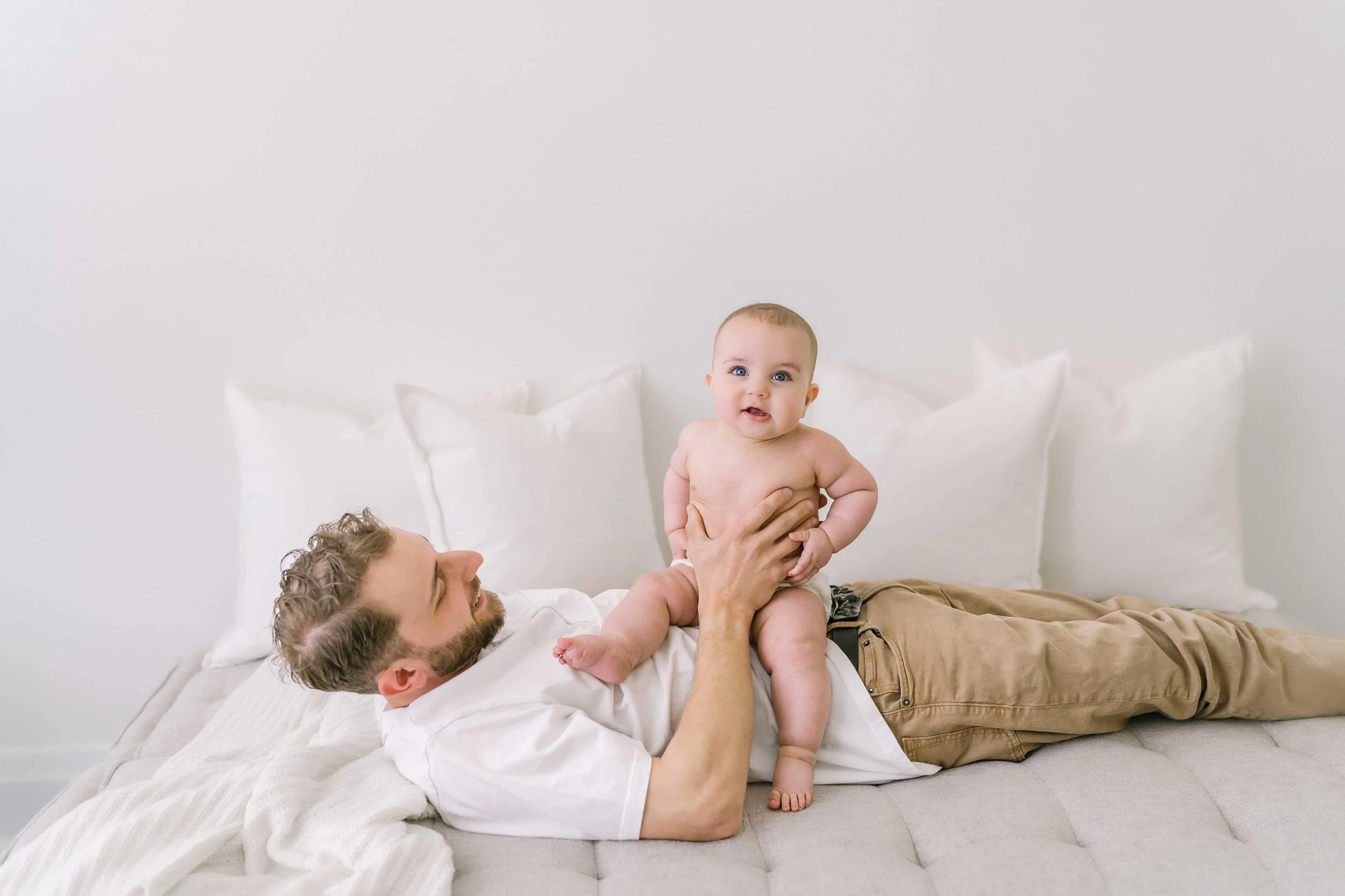 Mother holding baby lovingly from above during Grimsby baby photography session