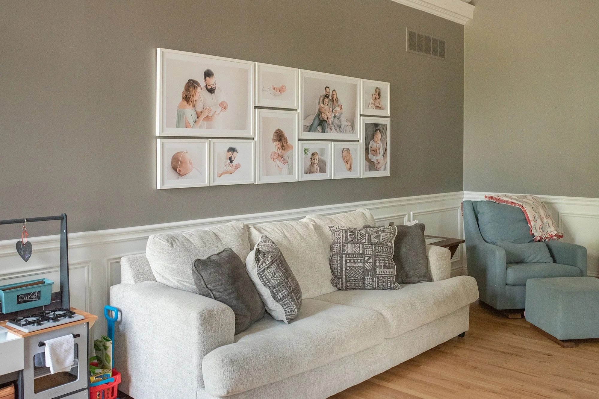 Gallery Wall Above Couch Featuring Heirloom Maternity Photo Albums in Niagara