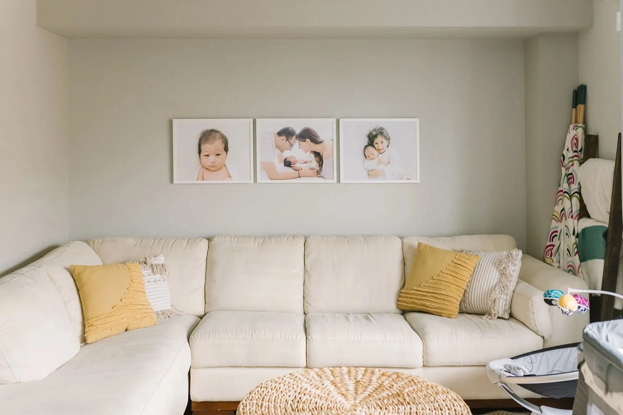 Framed Photos Above Sectional Paired with Heirloom Family Photo Albums in Ontario