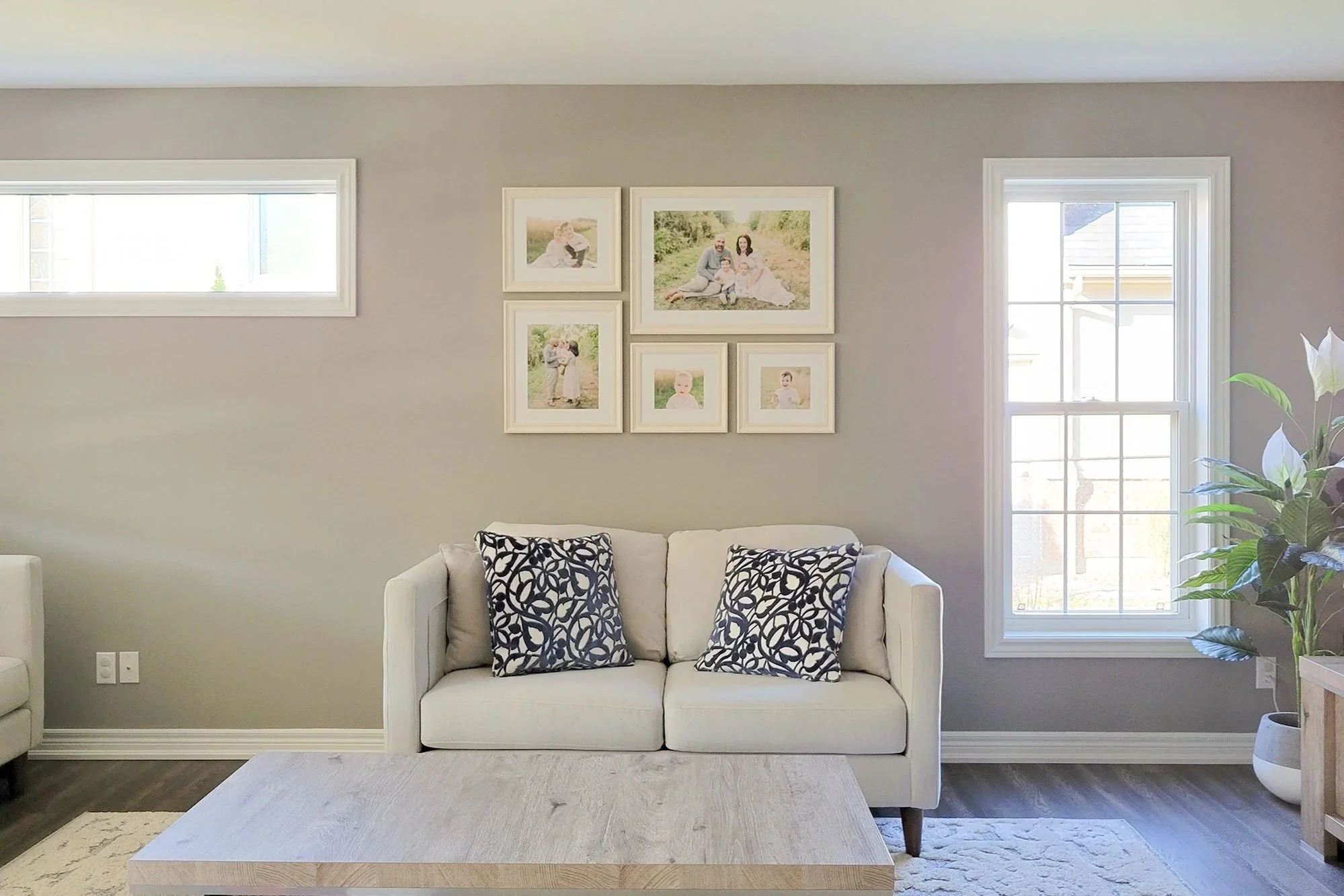 Bright Living Room Gallery Wall Featuring Heirloom Photo Albums in Niagara