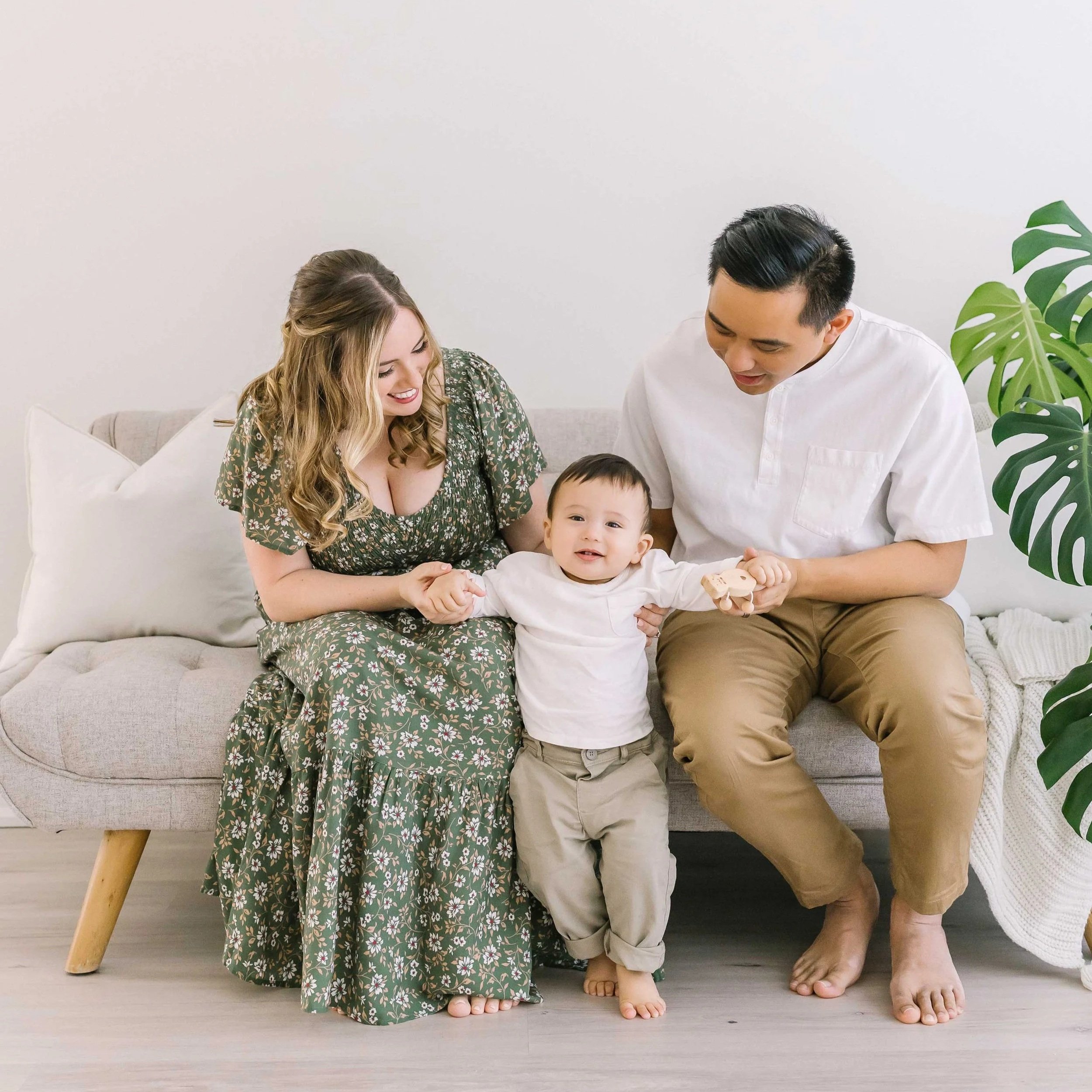 Happy one-year-old baby boy exploring a professional photography studio during his first birthday milestone session in Grimsby, Ontario.