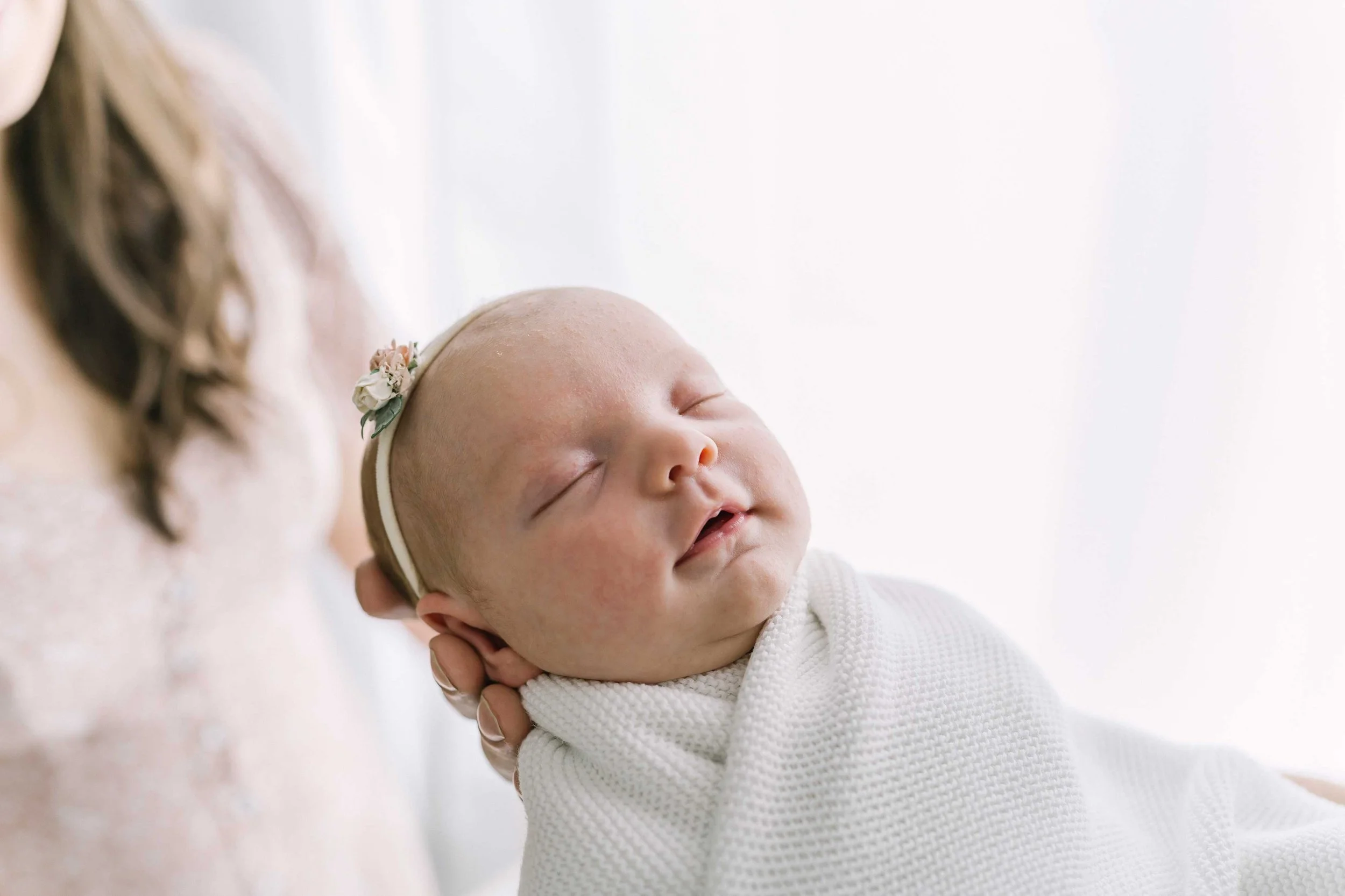 Close-up portrait of newborn baby during photography session