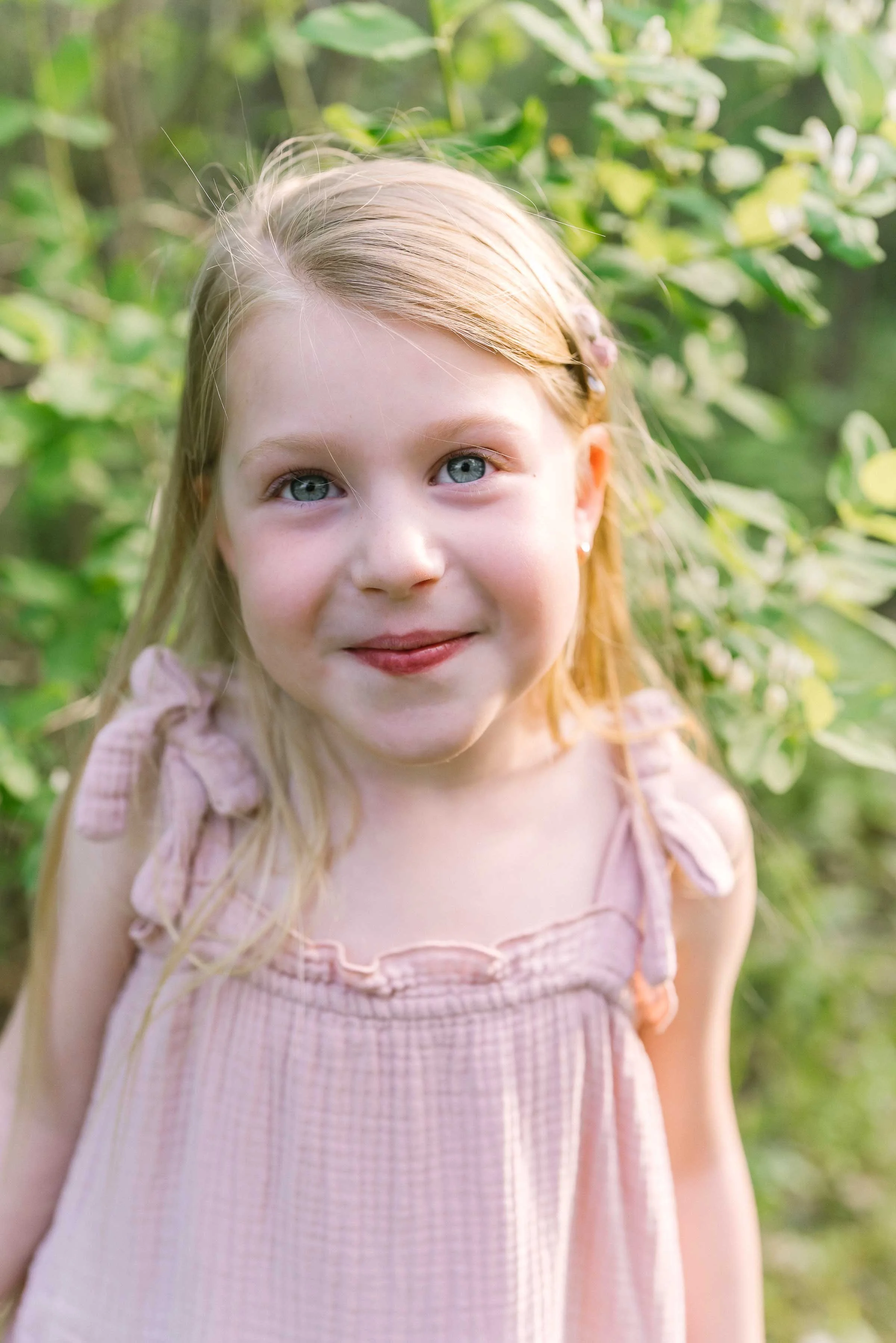 Young sisters posing for individual portraits during a family photography session in Niagara