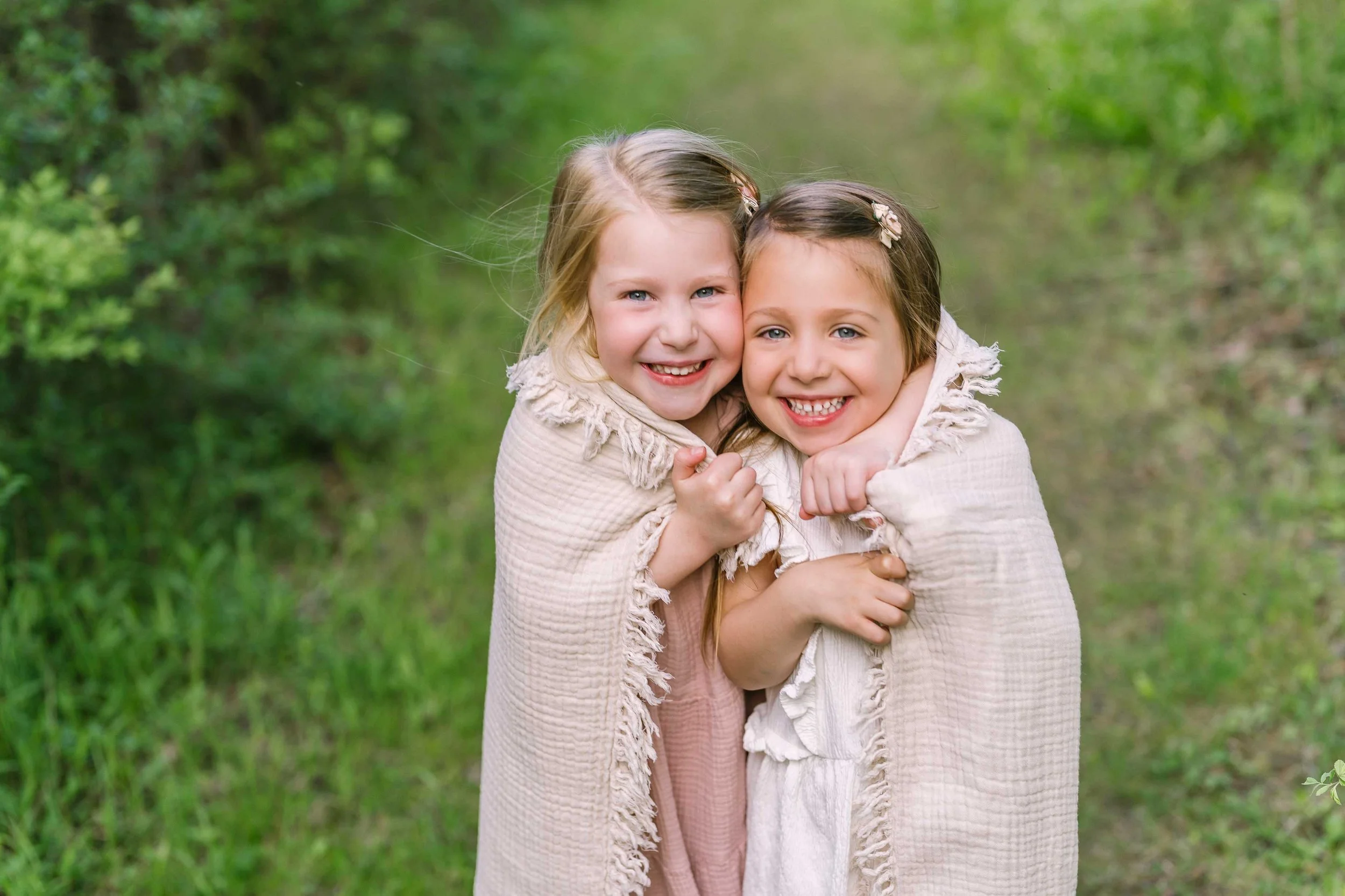 Sister smiling softly during an outdoor family portrait session in Niagara