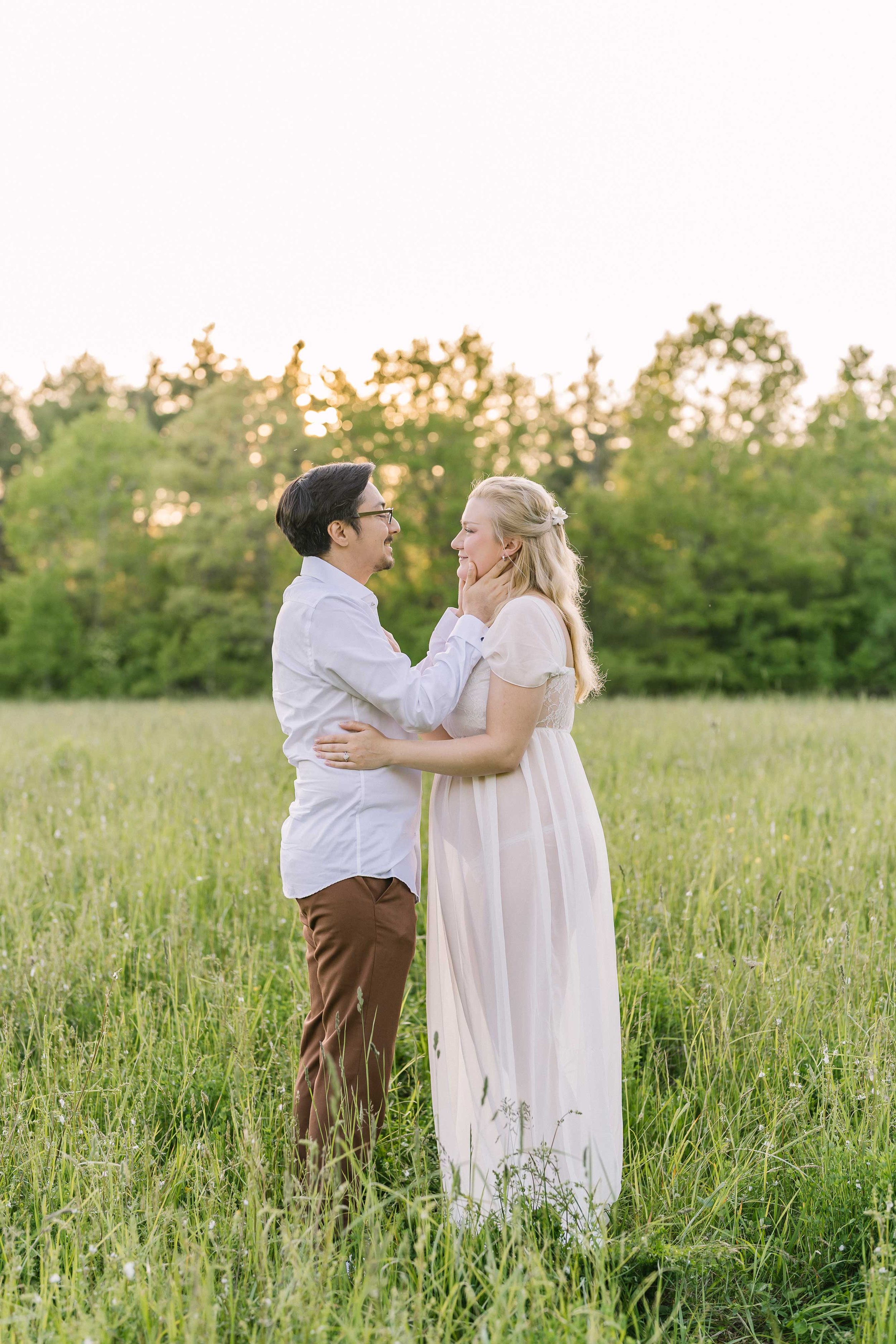 Pregnant couple enjoying a romantic sunset maternity session in Grimsby