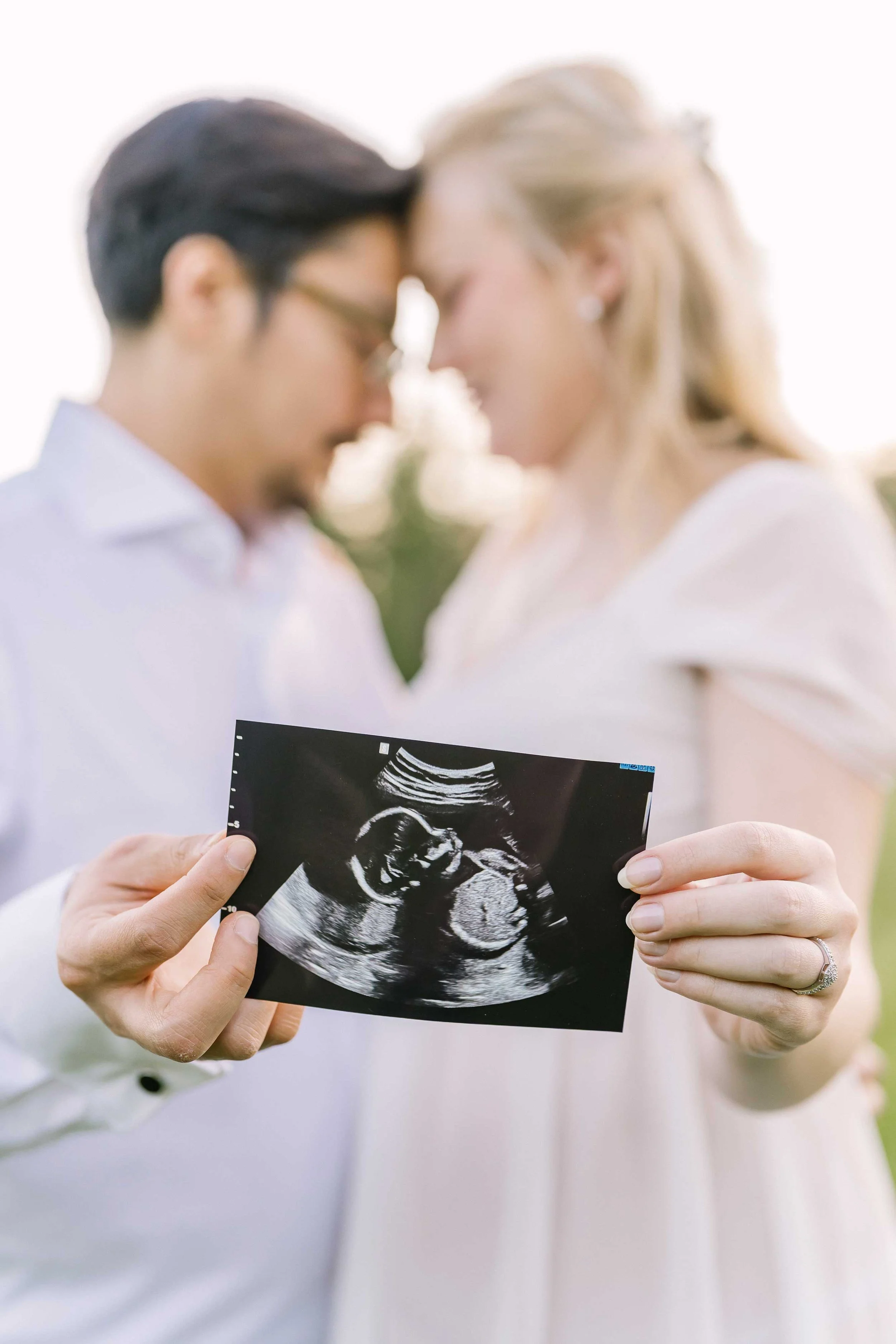 Expectant parents displaying their baby's ultrasound during maternity photos