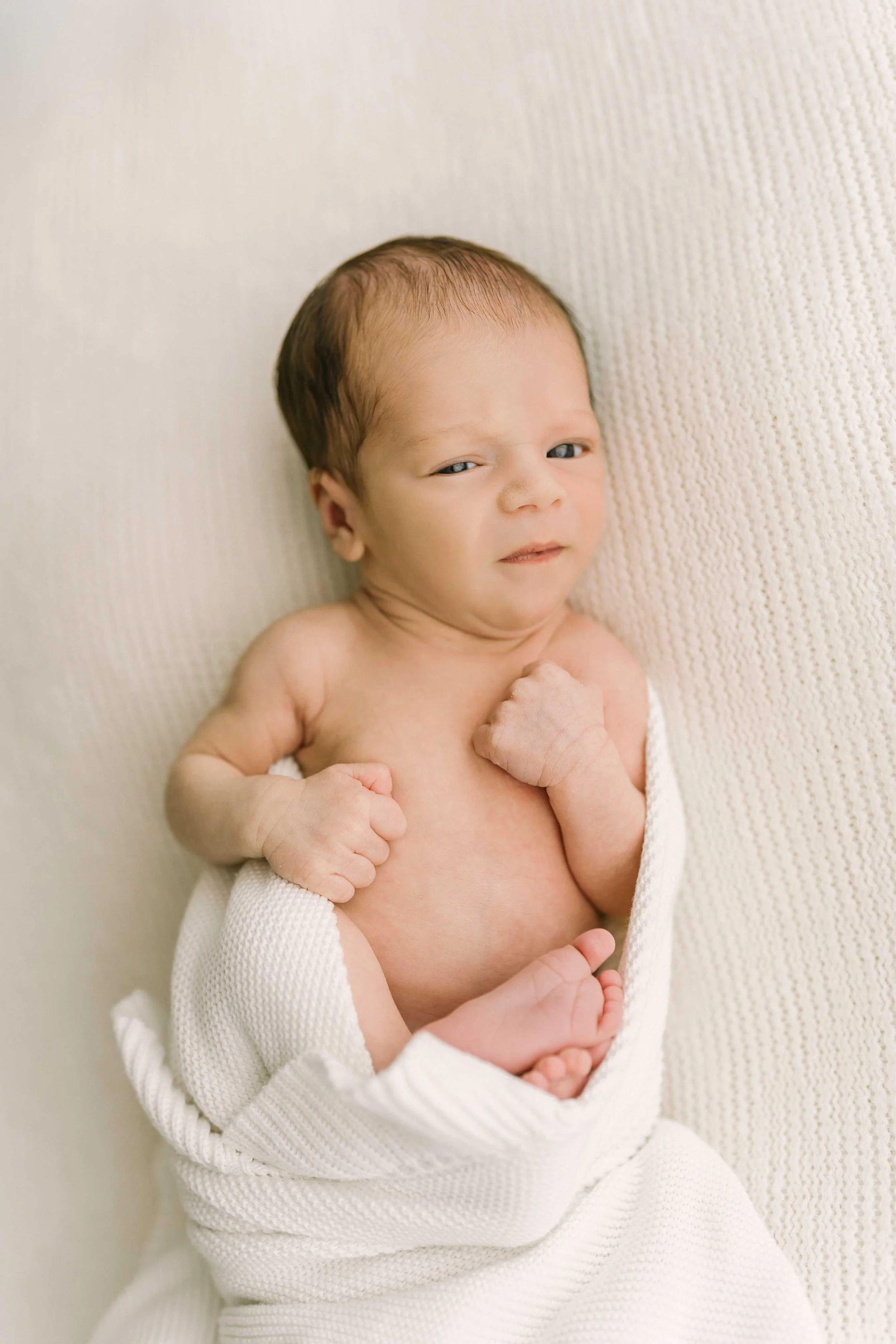 Chong newborn baby stretching during a newborn photography session in Grimsby