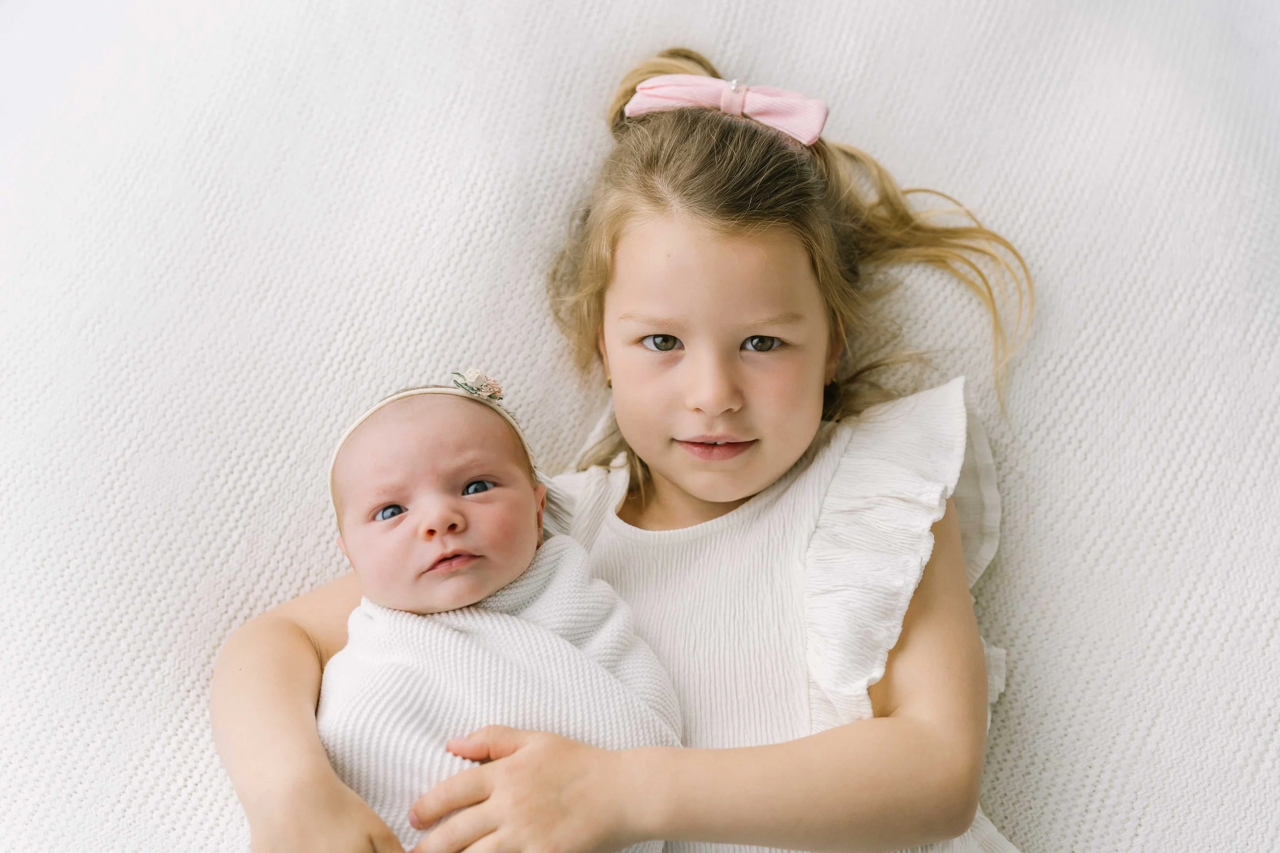 Sisters together during a newborn photography session