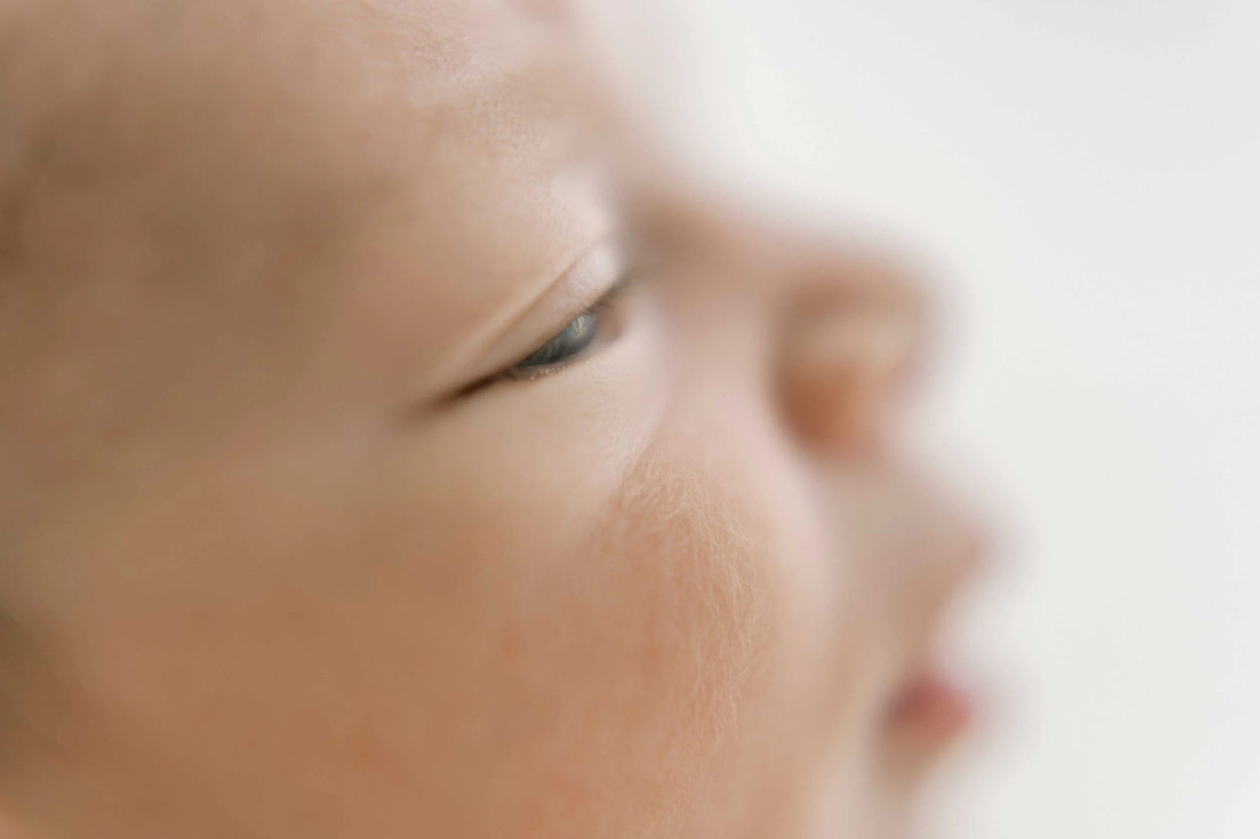 Close-up profile of Chong newborn baby showing tiny eyelashes and features