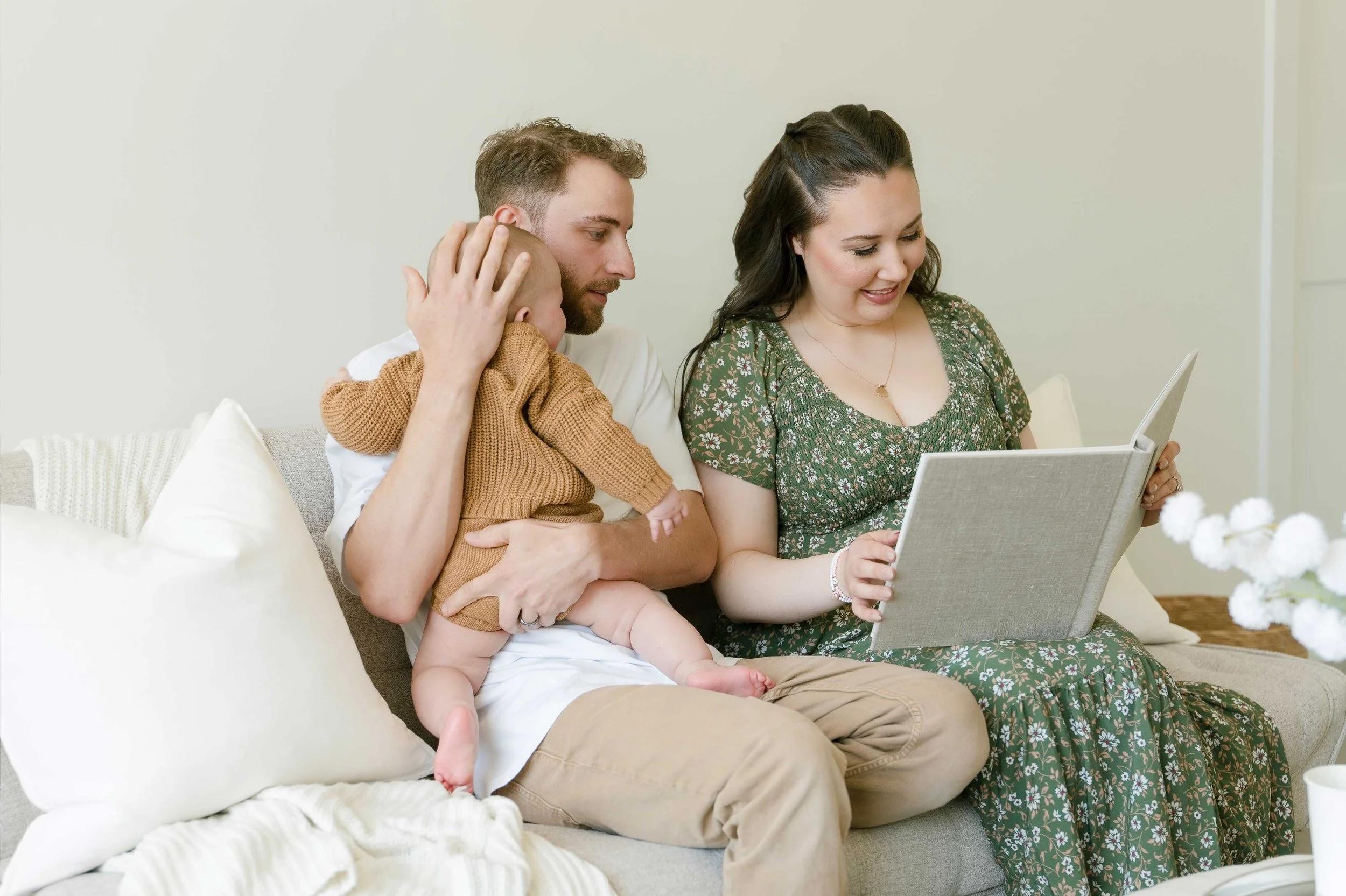 Family looking through heirloom family photo albums Niagara on couch togethe