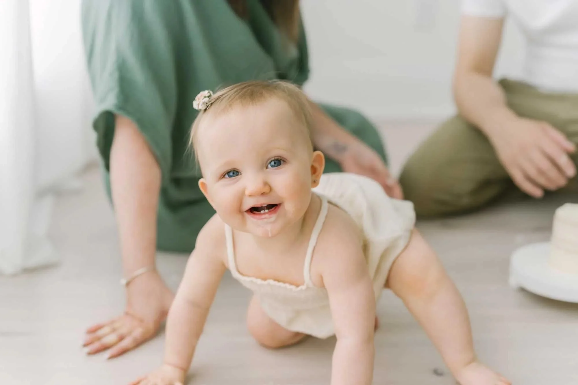 Little girl crawling on the floor at family and newborn photography studio in Niagara Region, Ontario