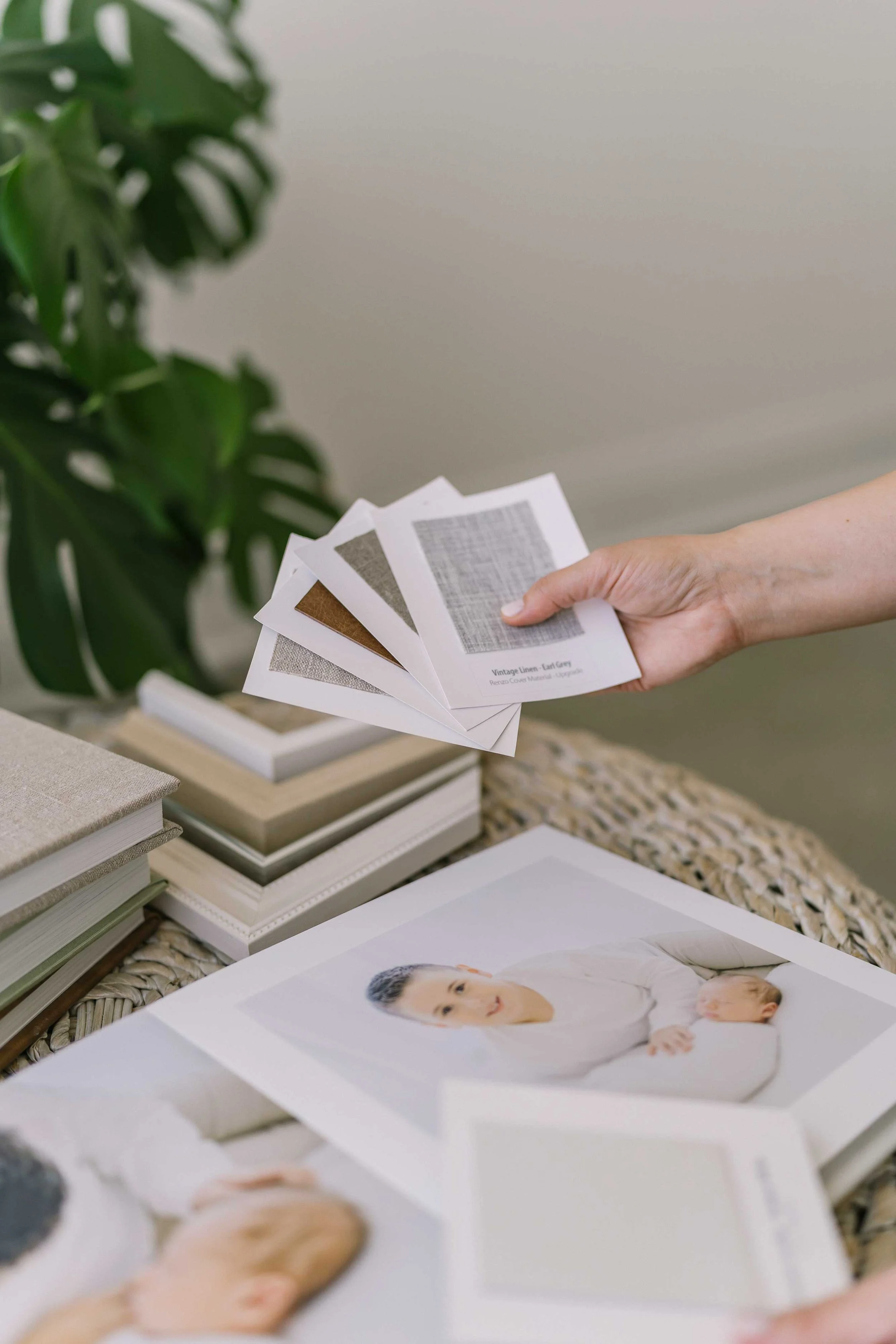 Framed prints and photo albums showcasing photography in Grimsby studio