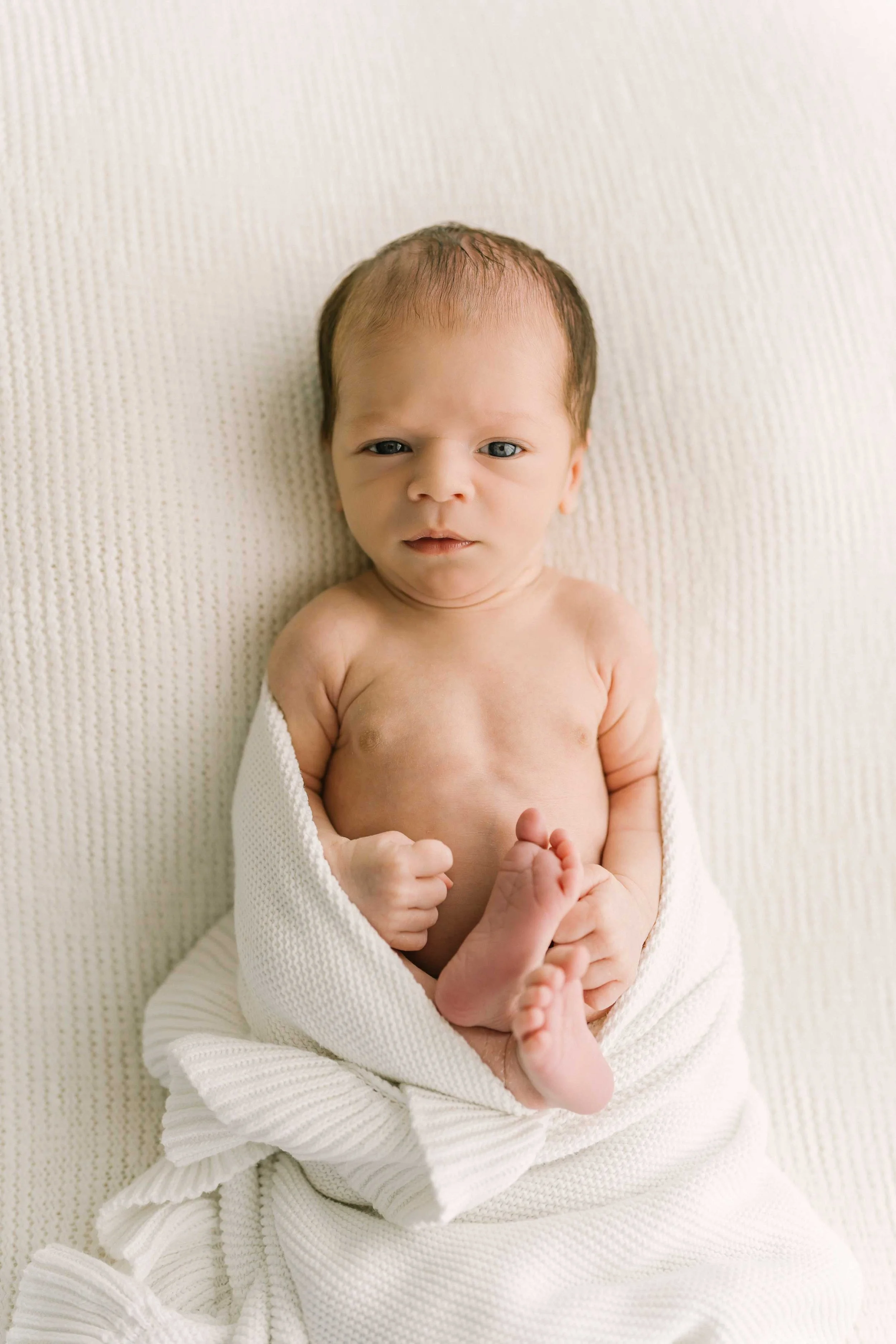 Chong newborn baby looking at the camera with open eyes