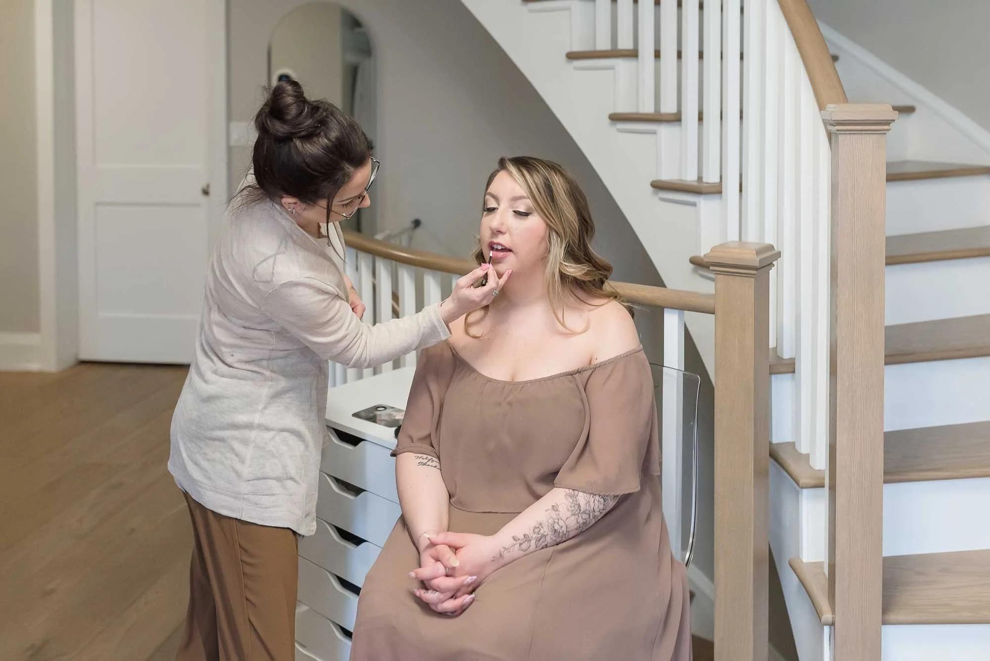 Mom getting hair and makeup done before newborn photography in Niagara Region, Ontario at Reflections Photography studio