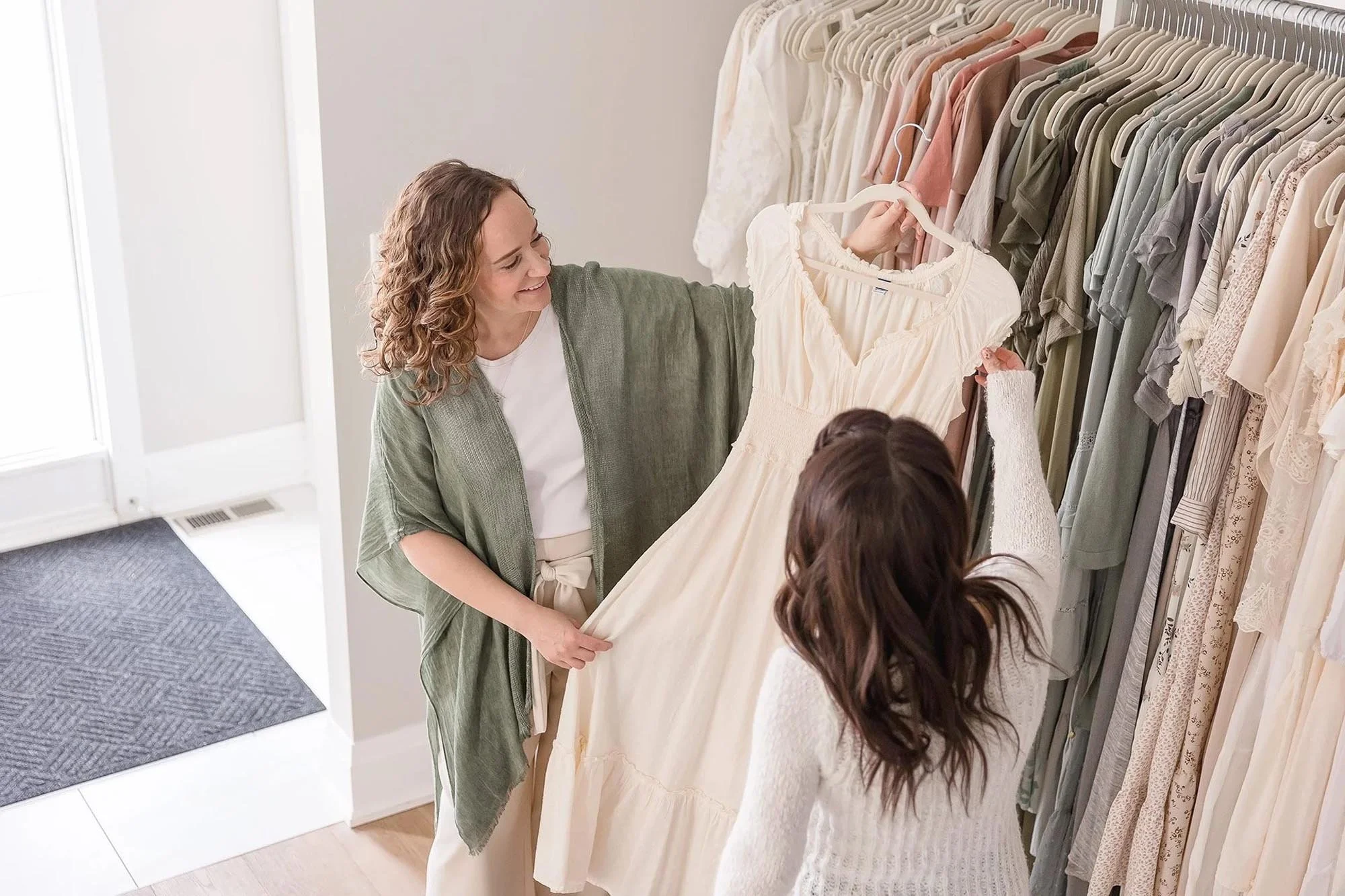 Client and photographer choosing wardrobe for full service Niagara newborn photography session