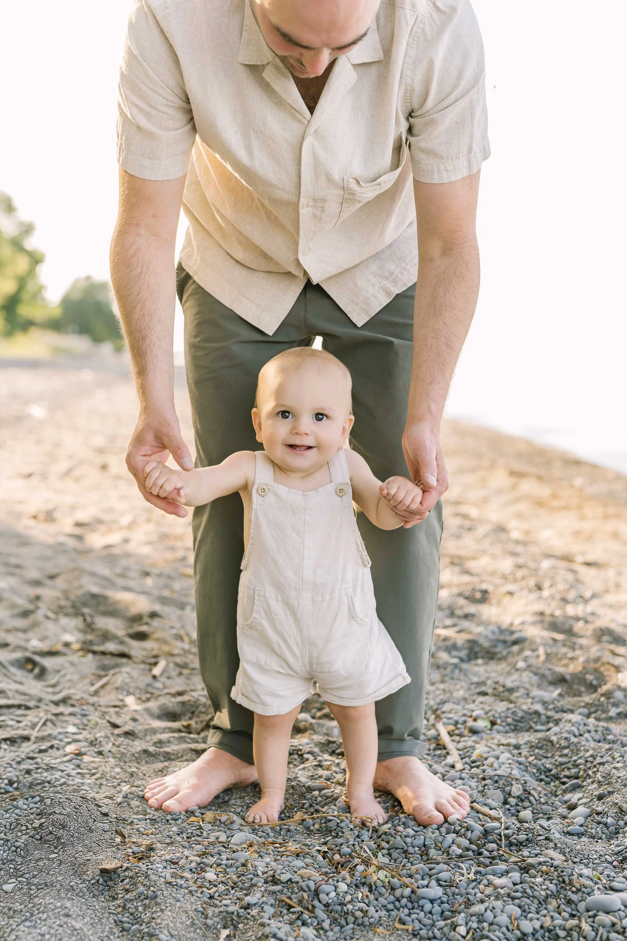 Chute family photography of dad helping baby stand