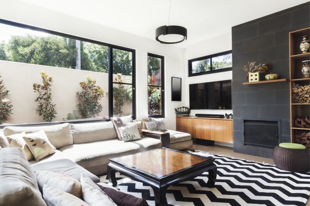 monochrome-living-room-with-wood-and-grey-tiling-accents-picture-id876786836.jpg