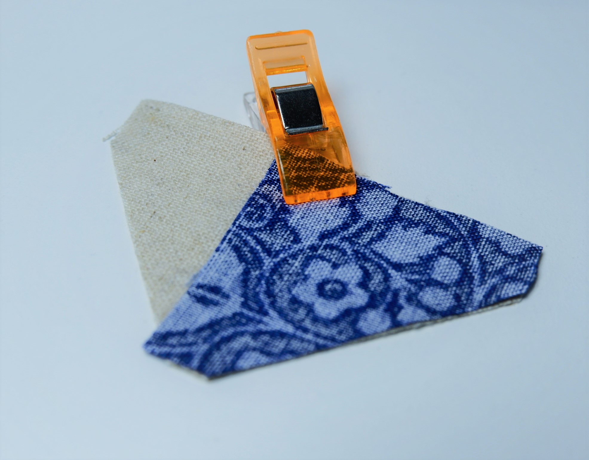 Clip a star point to one edge of your background triangles.