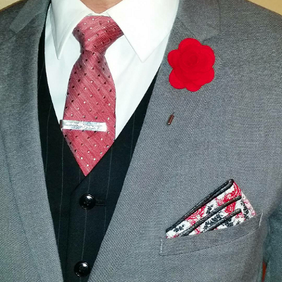 A muted blazer and bold accessories complement the microdot tie and in the red version of this box