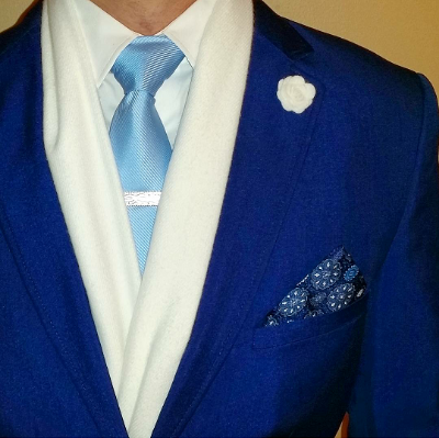 Channel Jack Frost in an ice blue tie, white scarf and snowflake pocket square