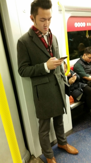 This young man heading home from a day at the office nails a classic professional look