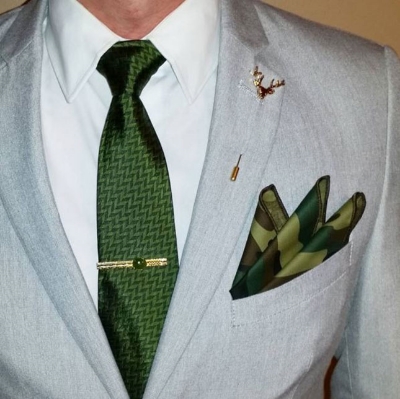 These earthy accessories work well with a neutral white shirt and light gray blazer. A vintage gold tie bar with a jade stone completes the look.