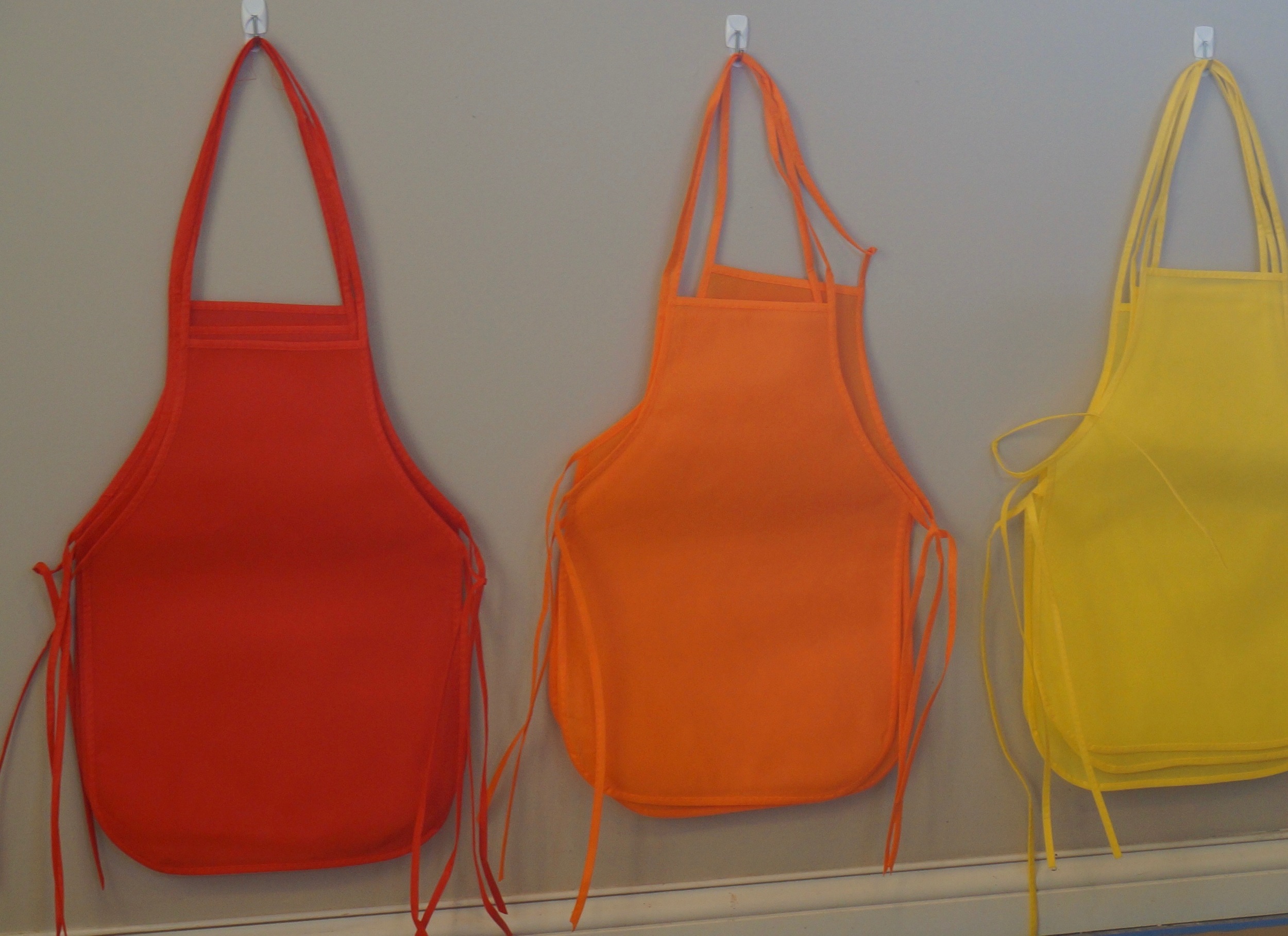 These colorful aprons help keep kids clean and make good party favors (adults can wear these too if you snip and re-tie the necks).