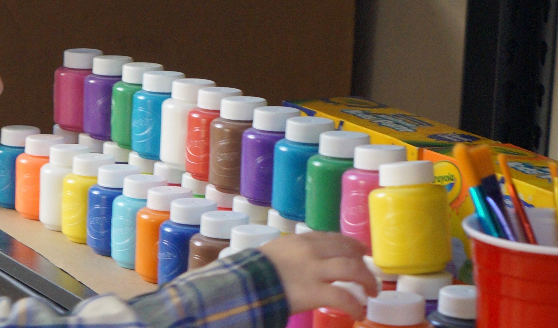 Stack 2-ounce bottles of Crayola paint in bold and neon for both simple decoration and easy access. Load up on brushes so that you can spend less time cleaning and more time painting with the kids.