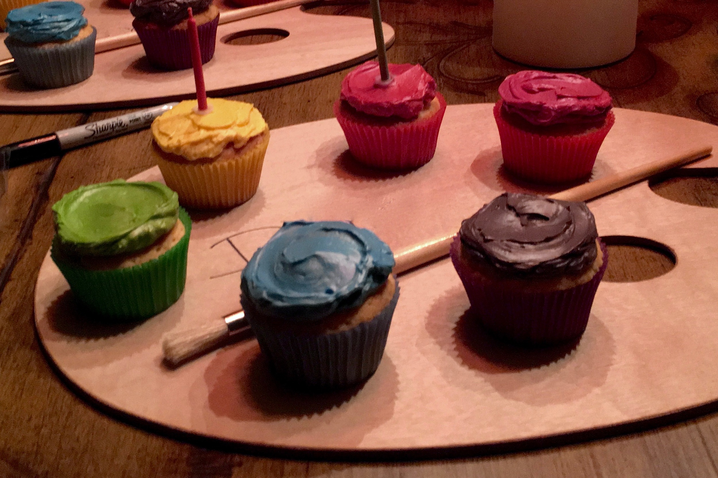 An painter's palette makes a great display for birthday cupcakes. 