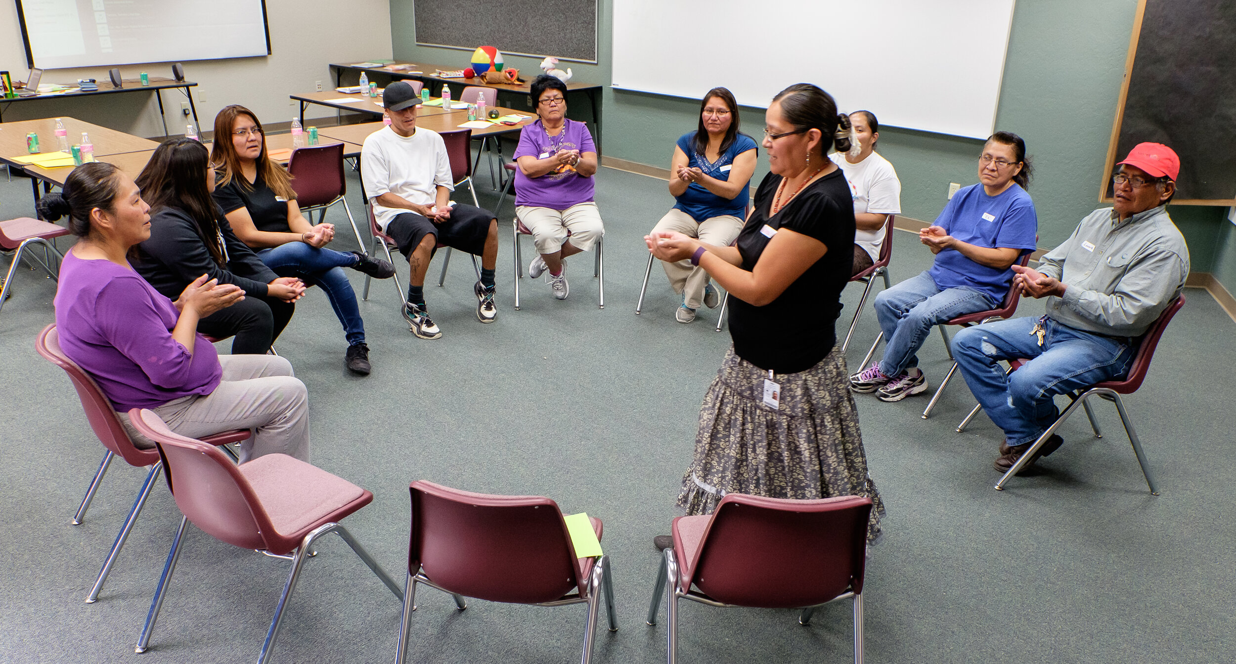 Navajo literacy teacher Valencia Edgewater leads a class of community members in a pronunciation exercise.