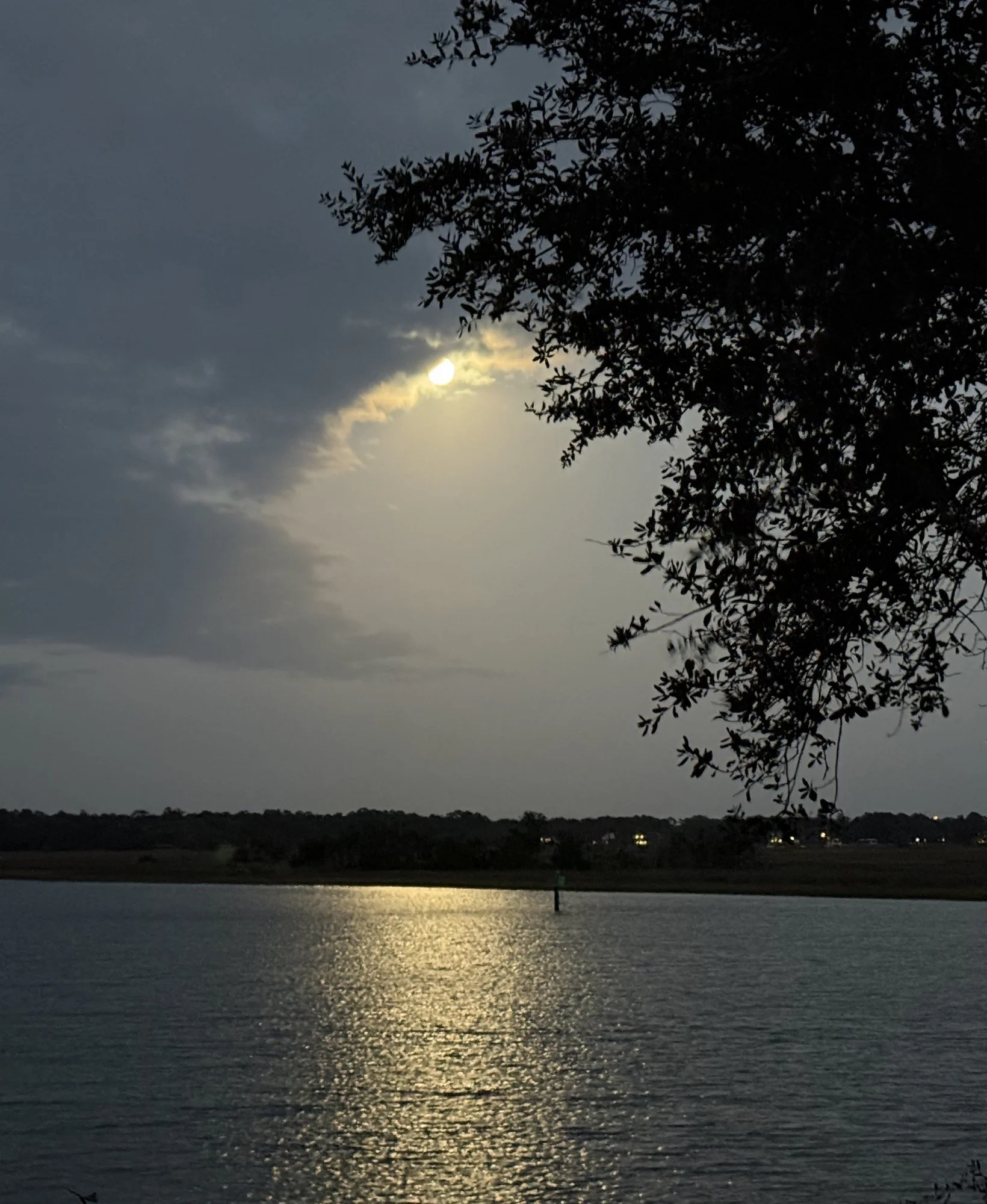 Moonlight breaking through clouds over the river near Savannah, photo by Emily Dillard - Sidereal Astrology FAQs