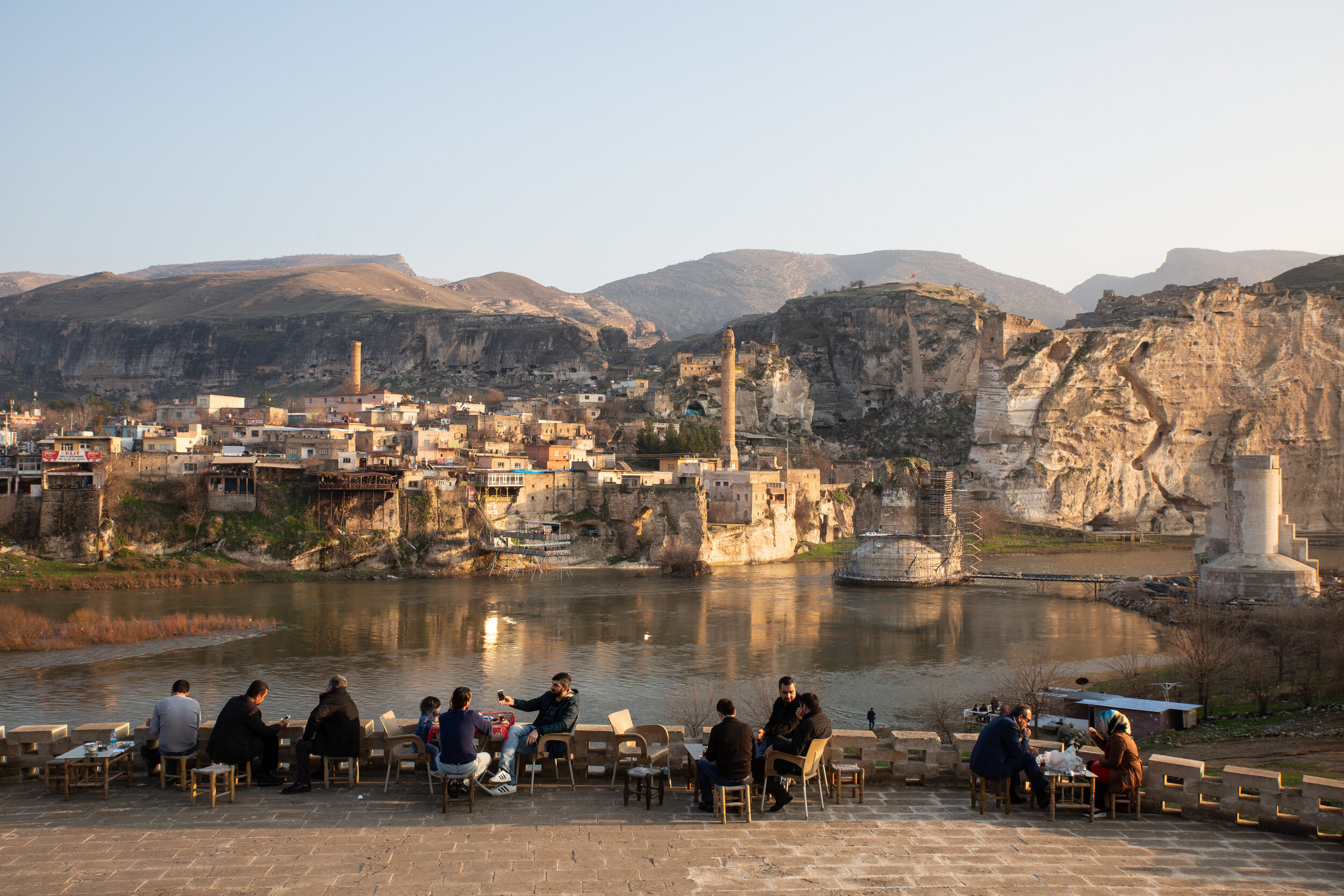 Visitors sit at a cafe on the north side of the Tigris River across from Hasankeyf in 2017