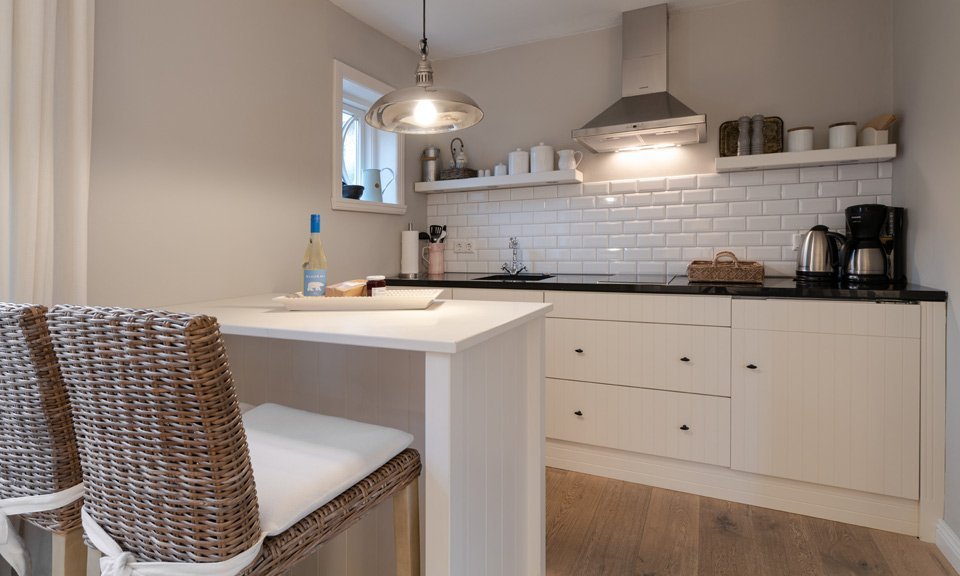 Well-appointed and snug - the open-plan kitchen with a counter - the perfect breakfast bar for two