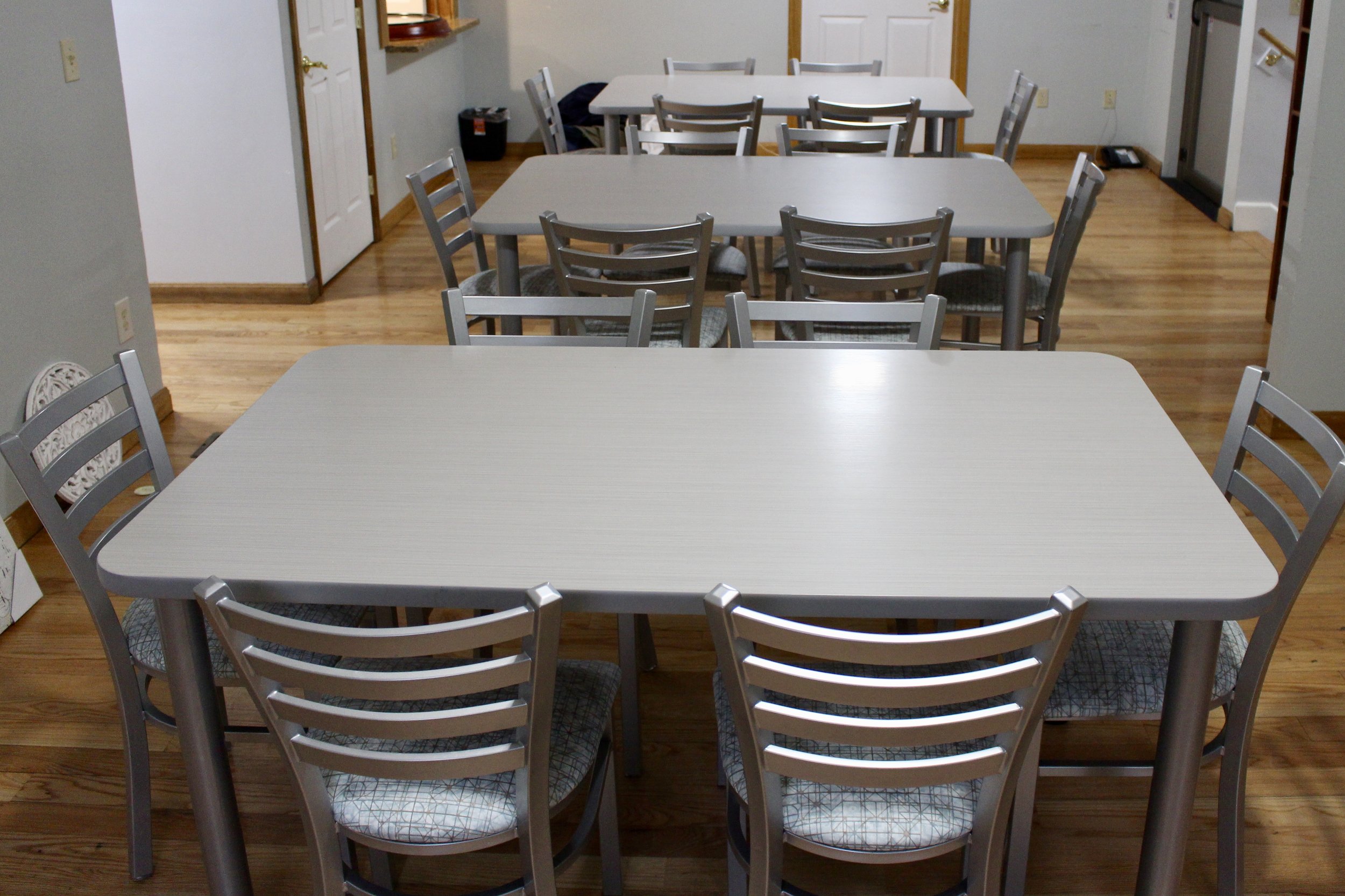 lamainte top tables with four metal legs; tuffy slat back chairs in silver with padded seats