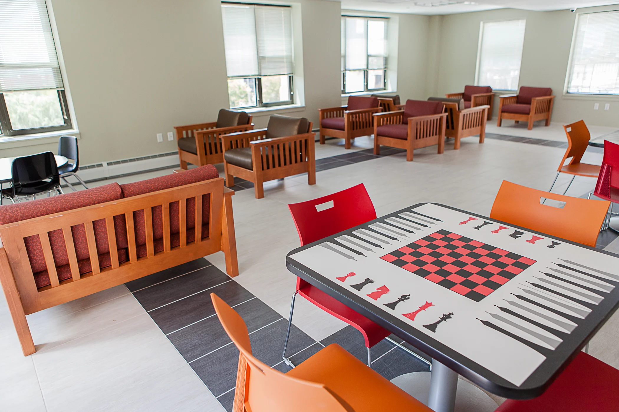 mission frame furntiure with game tables and duet chairs in transitional house common area
