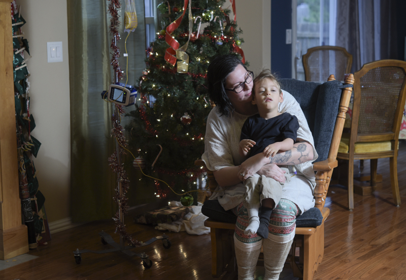 Ashley Markum holds her youngest son Ayden Markum, 3, in their home in Rogersville, MO. At 18 months old, Ayden was diagnosed with cerebral palsy and infantile spasms. After multiple medications failed to treat his seizures, Ayden's parents began to look into alternatives , which led them to CDB oil. "It has been the single most medicine that has helped," Ashley said, "After trying CBD for the first time...he laughed for the first time, and started to make eye contact; different developmental things along with seizure reduction." CBD oil is only available for patients who have specific siezure disorders and have a neurologist's recommendation. Although CDB oil does help Ayden reduce his seizures, it is not sufficient in subsiding the symptoms of his cerebral palsy. With THC, Ayden's muscle would be able to relax, but THC is not yet legally avilable for patients in Missouri. The Markums have previously debated on moving out of state to obtain the necessary medication for Ayden, but since CDB oil significantly helps with his Hypsarrhythmia, they decided to stay in Missouri and fight for the legalization of medical marijuana as a whole.